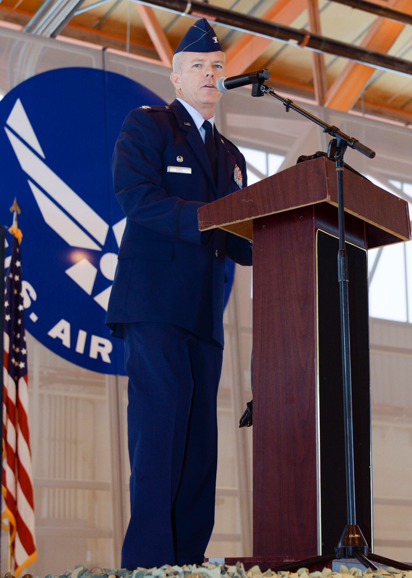 Col. Michael Shea, the 49th Maintenance Group commander, reflects on the many accomplishments of Maj. Jeurney K. Meekins, the 49th Aircraft Maintenance Squadron outgoing commander, during a Change of Command at Holloman Air Force Base, N.M. June 9, 2015. During the Change of Command, Shea was the presiding officer and Maj. Rebecca A. Hart, the 49th AMXS incoming commander, assumed command. The 49 AMXS generates over 73 thousand flight hours annually in support of the Air Force's largest and fastest growing Formal Training Unit and combat operations around the world.  Additionally, the 49 AMXS maintains a continuous forward presence with nearly 15 percent of assigned Airmen deployed in support of combat and humanitarian operations for multiple Combatant Commanders.  Finally, the squadron manages aircraft and resources valued at over $402 million and execute a $2.4 million budget. (U.S. Air Force photo by Staff Sgt. E’Lysia A. Wray/Released)