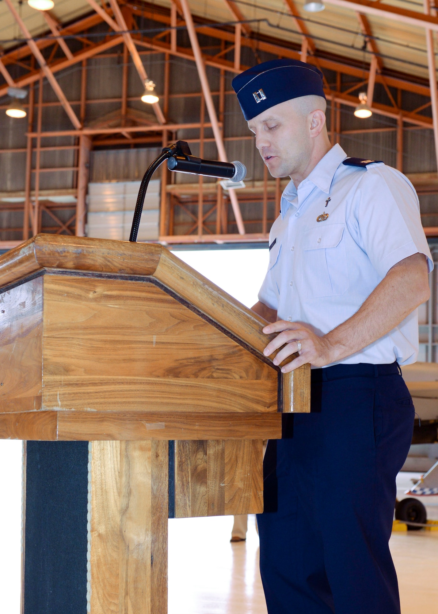 Chaplain Capt. Kevin Rash gives the opening prayer at the 49th Aircraft Maintenance Squadron Change of Command at Holloman Air Force Base, N.M. June 9, 2015. During the Change of Command, Col. Michael Shea, the 49th Maintenance Group commander was the presiding officer and Maj. Rebecca A. Hart, the 49th AMXS incoming commander, assumed command. The 49th AMXS has 359 assigned Airmen to maintain nine MQ-1B Predator remotely piloted aircraft in support of the 6th Reconnaissance Squadron, 22 MQ-9A Reaper remotely piloted aircraft in support of the 9th and 29th Attack Squadrons and 11 ground control stations and associated satellite communications assets that encompass command and control capability for the aircraft. (U.S. Air Force photo by Staff Sgt. E’Lysia A. Wray/Released)