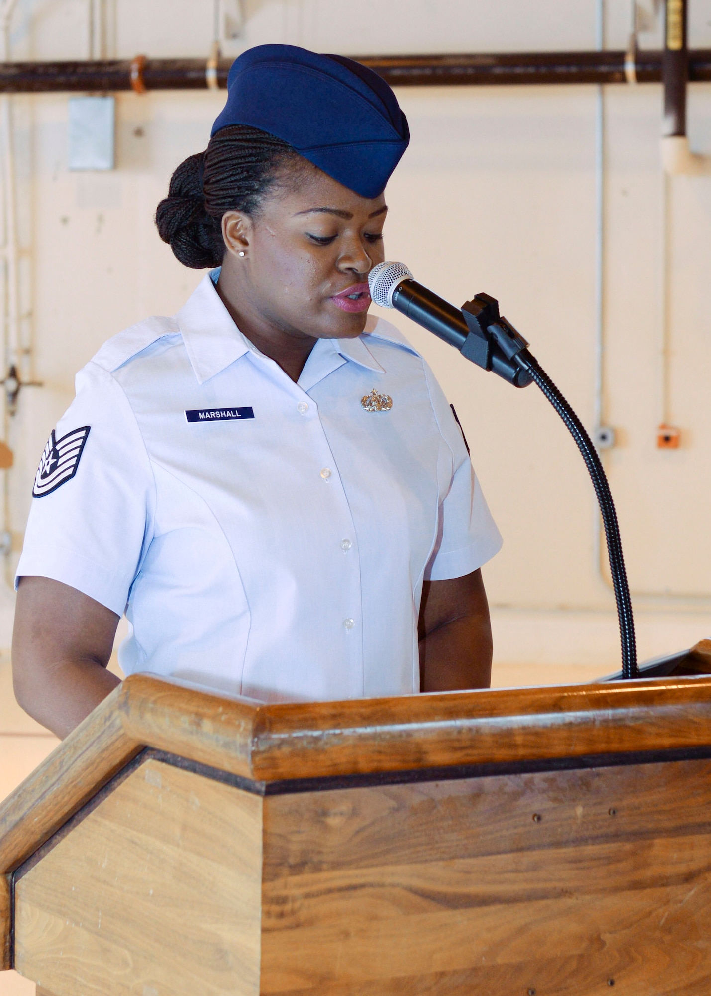 Tech. Sgt. Tonie Marshall, 49th Aircraft Maintenance Squadron unit training manager, gives the opening remarks during the 49th AMXS Change of Command at Holloman Air Force Base, N.M. June 9, 2015. During the Change of Command, Col. Michael Shea, the 49th Maintenance Group commander was the presiding officer and Maj. Rebecca A. Hart, the 49th AMXS incoming commander, assumed command. The 49th AMXS has 359 assigned Airmen to maintain nine MQ-1B Predator remotely piloted aircraft in support of the 6th Reconnaissance Squadron, 22 MQ-9A Reaper remotely piloted aircraft in support of the 9th and 29th Attack Squadrons and 11 ground control stations and associated satellite communications assets that encompass command and control capability for the aircraft. (U.S. Air Force photo by Staff Sgt. E’Lysia A. Wray/Released)