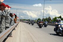 Residents of Great Falls, Mont., show their support as Missing in America Project motor cycle escorts riders pass in en route to a ceremony to honor the remains of six unclaimed Veterans June 5, 2015. Airmen and their families from Malmstrom Air Force Base lined the 10th Ave. South Bridge out of Great Falls and rendered a final salute to honor the service and sacrifice of the veterans, who were transferred and laid to rest in Montana State Cemetery at Fort Harrison in Helena, Montana.  (U.S. Air Force photo/Tech. Sgt. Chad Thompson)