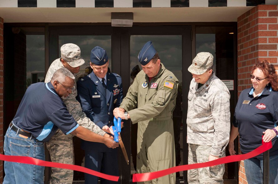 Col. Jason Armagost, 5th Bomb Wing commander, and Col. Thomas Rudy, 91st Missile Wing vice commander, along with other base leadership and 5th Force Support Squadron staff, cut a ribbon at Minot Air Force Base, N.D., June 5, 2015. The ribbon cutting ceremony marked the grand re-opening of Rockers, the base’s most recently renovated restaurant. (U.S. Air Force photo/Airman 1st Class Sahara L. Fales)