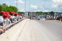 Residents of Great Falls, Mont., show their support as Missing in America Project motor cycle escorts riders pass in en route to a ceremony to honor the remains of six unclaimed Veterans June 5, 2015. Airmen and their families from Malmstrom Air Force Base lined the 10th Ave. South Bridge out of Great Falls and rendered a final salute to honor the service and sacrifice of the veterans, who were transferred and laid to rest in Montana State Cemetery at Fort Harrison in Helena, Montana.  (U.S. Air Force photo/Tech. Sgt. Chad Thompson)