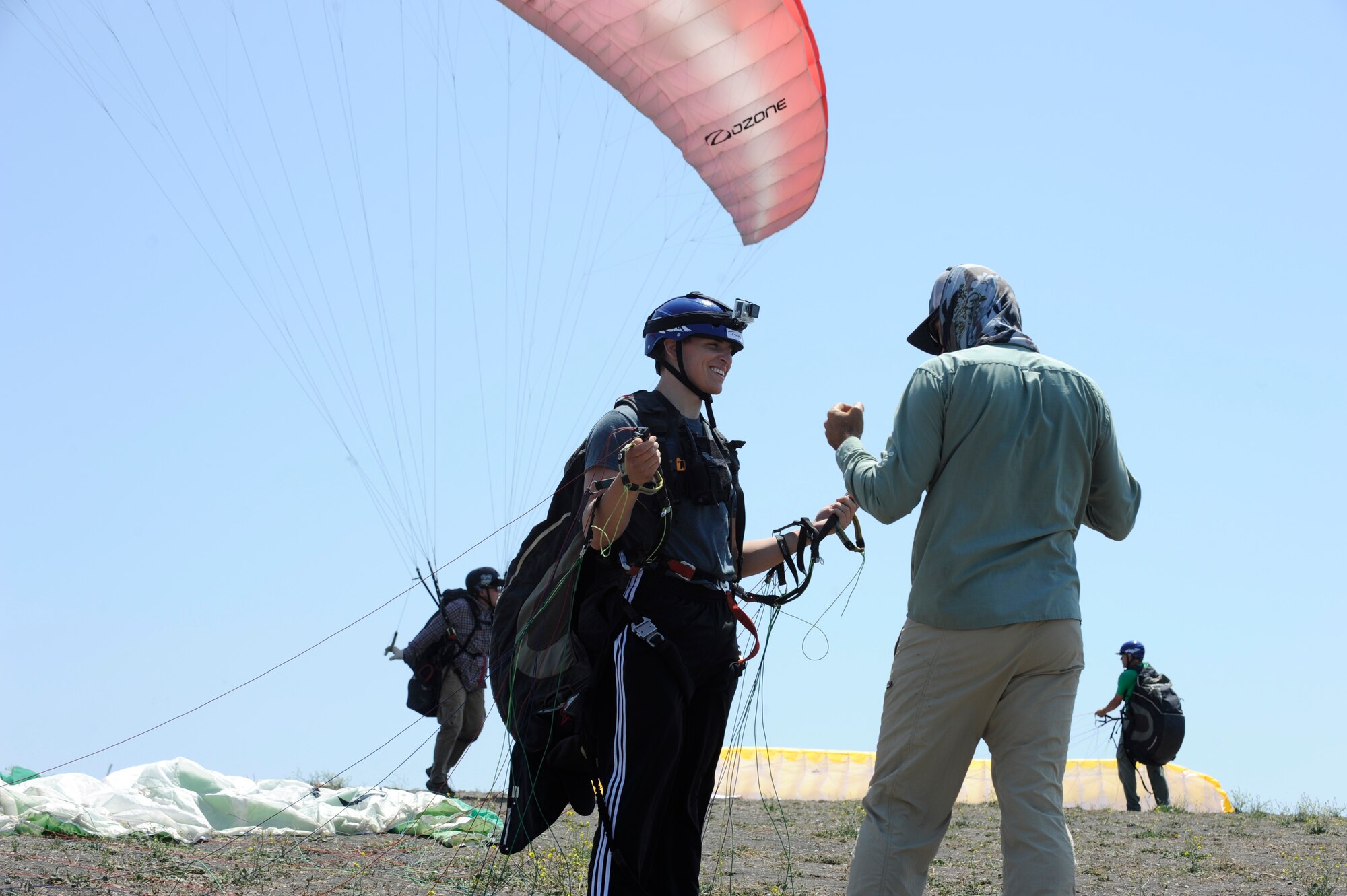 Airman 1st Class Joseph Weiler, 30th Medical Operations Squadron aerospace medical technician, receives pre-flight instructions from Kevin Howe, paragliding instructor, June 6, 2015, Santa Barbara, Calif. Vandenberg’s Outdoor Recreation features the Single Airman Initiative, a program that enables Airmen to participate in diverse and adventurous events year-round. (U.S. Air Force Photo by Airman 1st Class Robert J. Volio/Released)