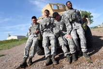 Competing in the Aces Cop Combat Challenge defenders from the 341st Security Forces Group push a Humvee weighing more than 13,000 pounds uphill June 5, 2015, at Malmstrom Air Force Base, Mont.  This was the fourth annual challenge put on by Security Forces to encourage Airmen to push their body and minds outside the normal routine. (U.S. Air Force photo/Chris Willis)