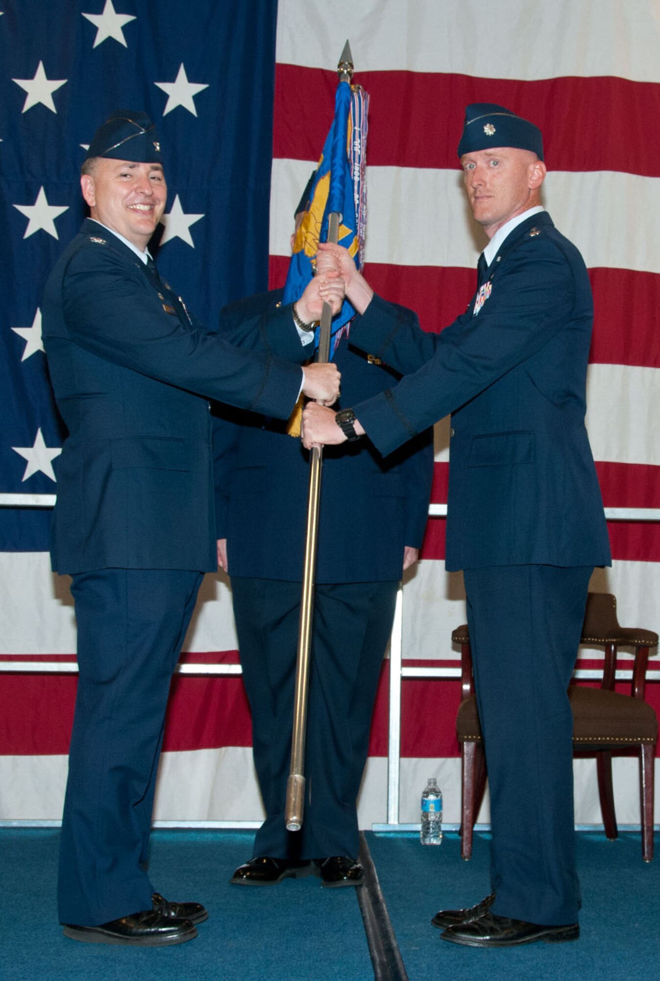 Lt. Col. Michael Drost receives the 71st Operations Support Squadron guidon from Col. John Cinnamon, the 71st Operations Group commander, during a change of command ceremony June 4 in the Armed Forces Reserve Center at Vance Air Force Base, Oklahoma. Drost assumed command from Lt. Col. David Woodley. (U.S. Air Force photo / Terry Wasson)