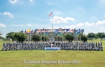 Joint Base San Antonio-Lackland technical sergeant selects pose for a group photo at JBSA-Lackland's parade grounds.