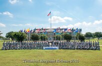Joint Base San Antonio-Lackland technical sergeant selects pose for a group photo at JBSA-Lackland's parade grounds.