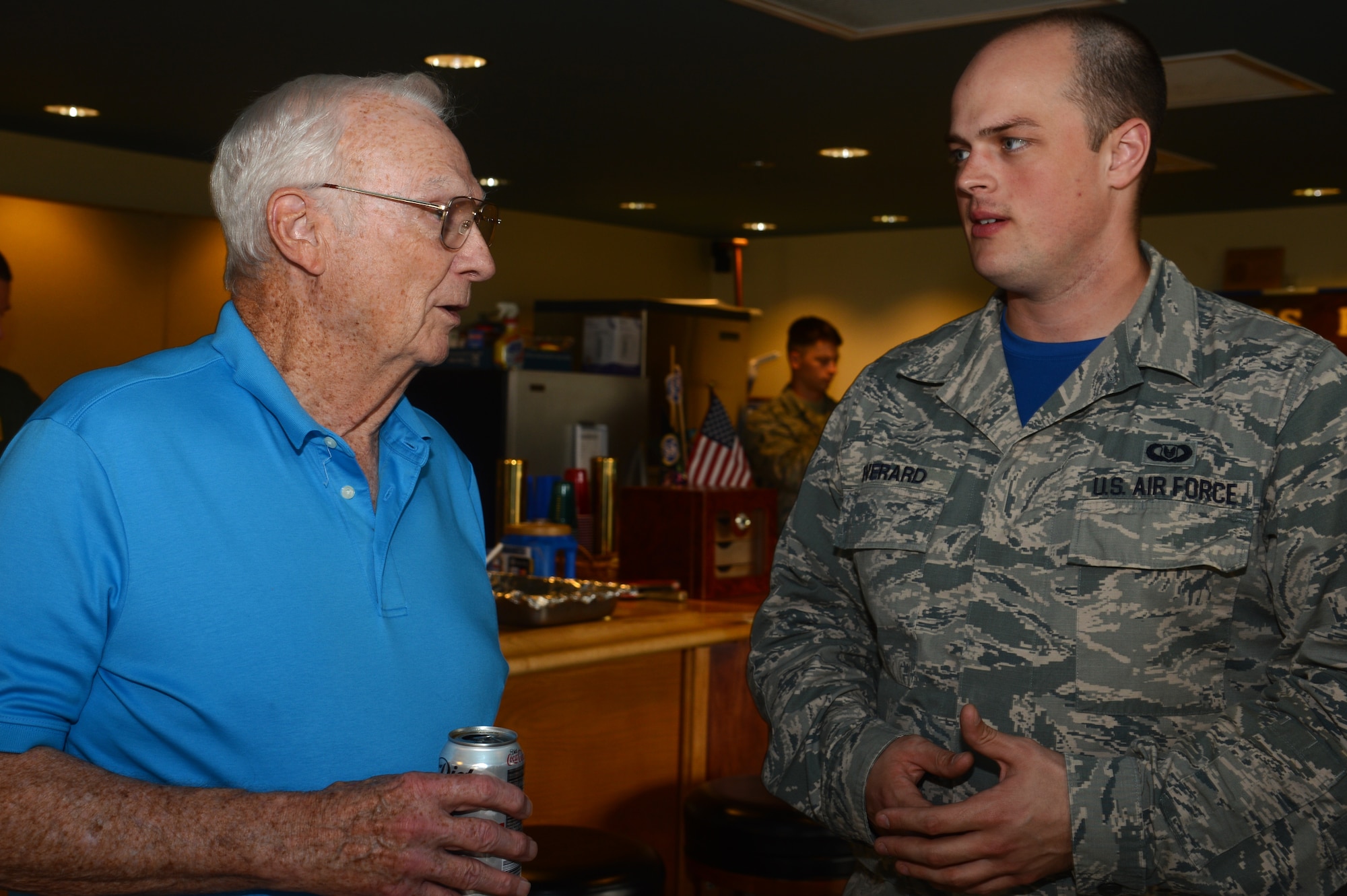 A retired U.S. Air Force Wild Weasel speaks to a current Wild Weasel Airman at Shaw Air Force Base, S.C., June 5, 2015. The Wild Weasels gathered for lunch at the 55th Fighter Squadron during their 50th anniversary celebration. (U.S. Air Force photo by Senior Airman Jonathan Bass/Released)