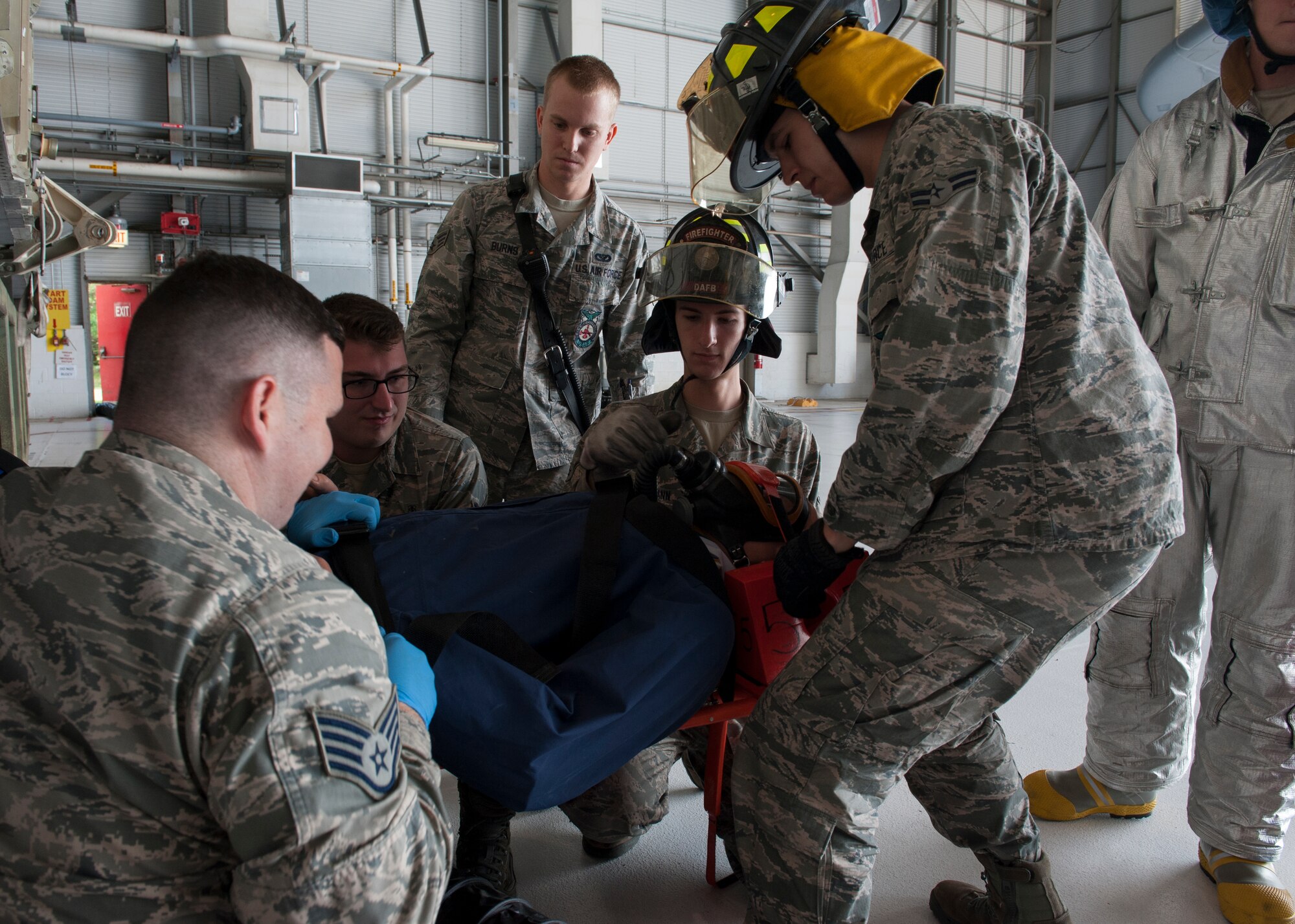 Airmen and personnel from the 436th Civil Engineer and 436th Medical Operations Squadrons immobilized an exercise dummy on a stretcher during an in-wing fuel cell extraction exercise June 8, 2015, at Dover Air Force Base, Del. This exercise was a coordinated effort between the 436th Maintenance Squadron, the 436th MDOS, the 436th CES, and the 436th Airlift Wing Safety Office. (U.S. Air Force photo/Airman 1st Class Zachary Cacicia)