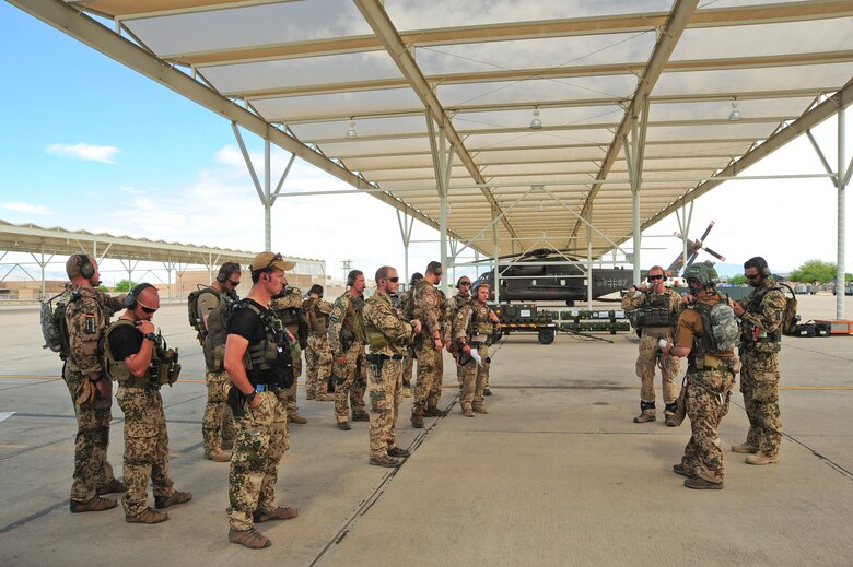 German and U.S. Air Force pararescuemen check their radios before a training exercise during Angel Thunder 2015 at Davis-Monthan Air Force Base, Ariz., June 7, 2015.  Angel Thunder is an Air Combat Command-sponsored personnel recovery exercise for combat air force, joint, allied and interagency participants.  (U.S. Air Force photo by Airman 1st Class Chris Massey/Released)
