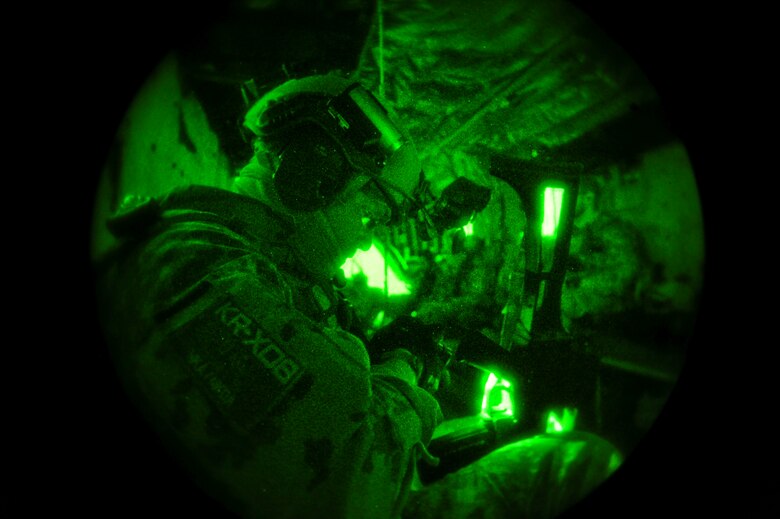 A German Air Force pararescueman prepares his gear while flying over Southern California in a German Air Force CH-53GS helicopter during Angel Thunder 2015, June 7, 2015.  Angel Thunder is the world's largest personnel recovery exercise.  D-M hosted 11 partner nations and nine interagencies with a common goal to train personnel recovery forces to prepare, plan, execute and adapt for rescue missions.  (U.S. Air Force photo by Airman 1st Class Chris Massey/Released)