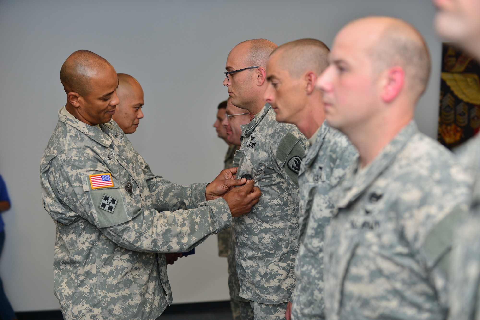 U.S. Army Command Sgt. Maj. Lloyd G. Morant, Aviation Logistics Noncommissioned Officer Academy commandant, awards instructors the Army Instructor Badge at Fort Eustis, Va., June 5, 2015. The badge is awarded as a part of the Training and Doctrine Command Institute for NCO Professional Development’s Instructor Development Recognition Program, which coaches, mentors and trains instructors to teach multiple learning styles. (U.S. Air Force photo by Staff Sgt. Natasha Stannard/Released)