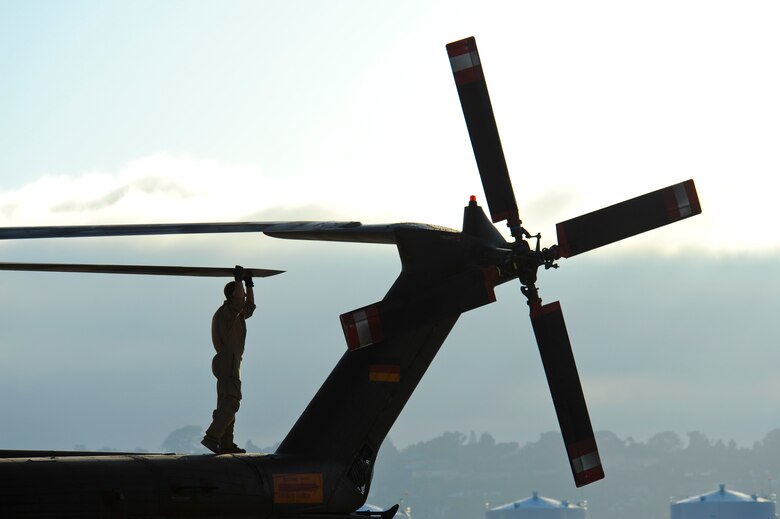 A German Air Force maintainer performs pre-flight checks on a German Air Force CH-53GS helicopter during Angel Thunder 2015 at Naval Air Station North Island, Calif., during Angel Thunder 2015 June 7, 2015.  Angel Thunder is the world's largest personnel recovery exercise.  D-M hosted 11 partner nations and nine interagencies with a common goal to train personnel recovery forces to prepare, plan, execute and adapt for rescue missions.   (U.S. Air Force photo by Airman 1st Class Chris Massey/Released)