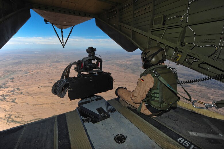 A German Air Force aerial gunner sits on the ramp of a German Air Force CH-53GS helicopter while flying over southern Arizona during Angel Thunder 2015, June 7, 2015.  Angel Thunder is the world's largest personnel recovery exercise.  D-M hosted 11 partner nations and nine interagencies with a common goal to train personnel recovery forces to prepare, plan, execute and adapt for rescue missions.   (U.S. Air Force photo by Airman 1st Class Chris Massey/Released)