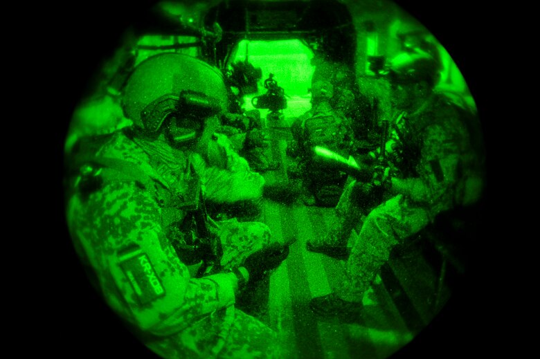 German Air Force pararescuemen prepare their gear while flying over Southern California in a German Air Force CH-53GS helicopter during Angel Thunder 2015, June 7, 2015.  The objective of Angel Thunder is to train personnel recovery forces to prepare, plan, execute and adapt for a rescue mission.  (U.S. Air Force photo by Airman 1st Class Chris Massey/Released)