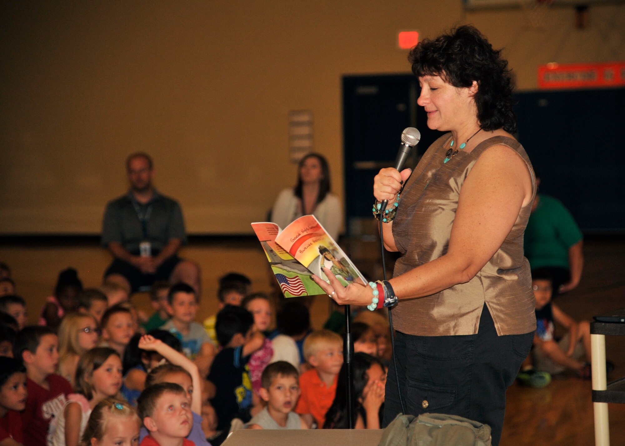 Graciela Tiscareño-Sato, children’s book author and former U.S. Air Force captain, reads her book “Good Night Captain Mama/Buenas Noches Captain Mama” to children at Michael Anderson Elementary June 8, 2015, at Fairchild Air Force Base, Wash. Tiscareño-Sato’s book series is about a military pilot and her children based at FAFB. She read her first book titled “Good Night Captain Mama/Buenas Noches Captain Mama” and also handed out a copy of her book to students at MAE. (U.S. Air Force photo/ Airman 1st Class Taylor Bourgeous)