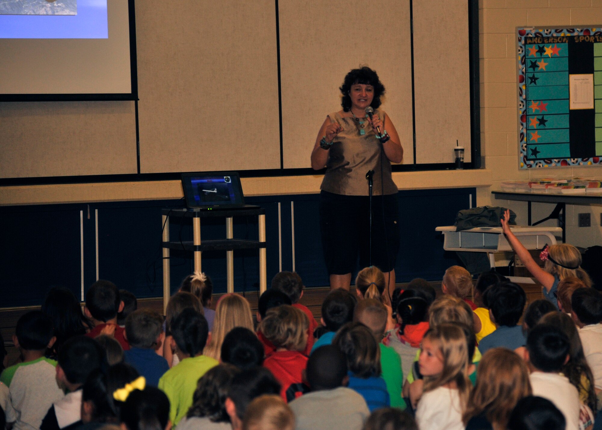 Graciela Tiscareño-Sato, children’s book author and former U.S. Air Force captain, speaks to children at Michael Anderson Elementary June 8, 2015, at Fairchild Air Force Base, Wash. Tiscareño-Sato is a nine-time award-winning author, she came to MAE to speak to the children about her previous career as a pilot. She flew as a navigator and instructor with the 93rd Air Refueling Squadron while she was stationed at FAFB. (U.S. Air Force photo/ Airman 1st Class Taylor Bourgeous)