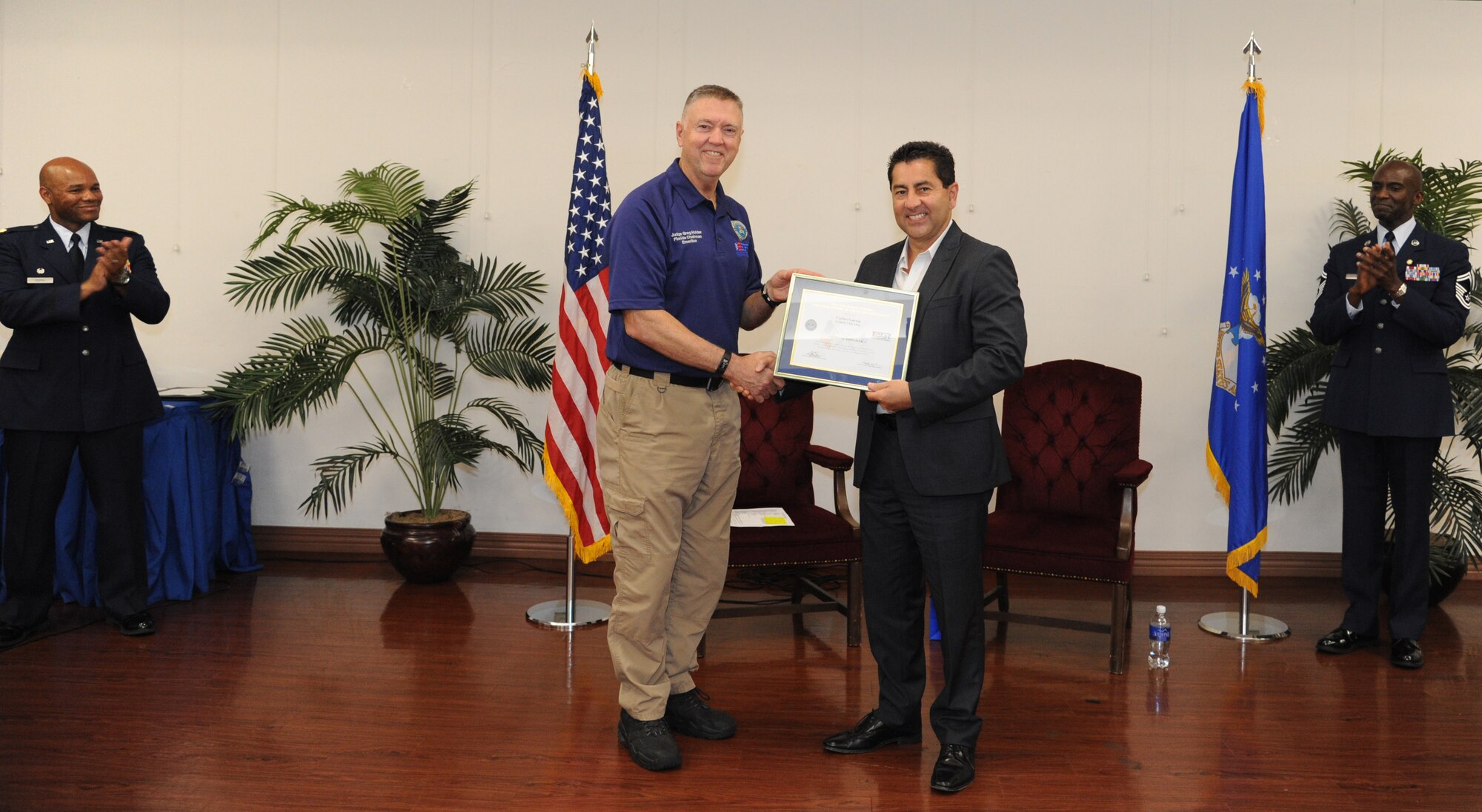 Florida Employer Support of the Guard and Reserve Chairman Emeritus, Judge Gregory Holder, presents Carlos Garcia the Patriot award  June 7th, 2015, at MacDill Air Force Base. Garcia was nominated by an employee of his, Senior Master Sgt. Nathaniel Greenwich, who wanted to show his appreciation to his employer at U.S. Southern Command in south Florida. The Patriot Award is awarded to employers who go above and beyond to support the National Guard or Reserve military service of their employees. (U.S. Air Force Photo by Staff Sgt. Adam C. Borgman)