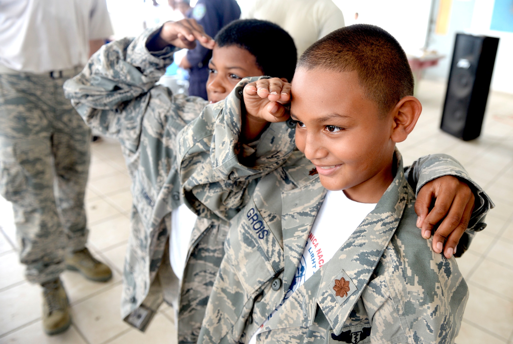 Children attending the Guardian of the Fatherland event at Puerto Castillo Naval Base in Trujillo, Honduras, June 6, 2015, try on the U.S. Air Force uniforms. More than 20 NEW HORIZONS Honduras 2015 personnel volunteered to participate in the event. NEW HORIZONS was launched in the 1980s and is an annual joint humanitarian assistance exercise that U.S. Southern Command conducts with a partner nation in Central America, South America or the Caribbean. The exercise improves joint training readiness of U.S. and partner nation civil engineers, medical professionals and support personnel through humanitarian assistance activities. (U.S. Air Force photo by Capt. David J. Murphy/Released)