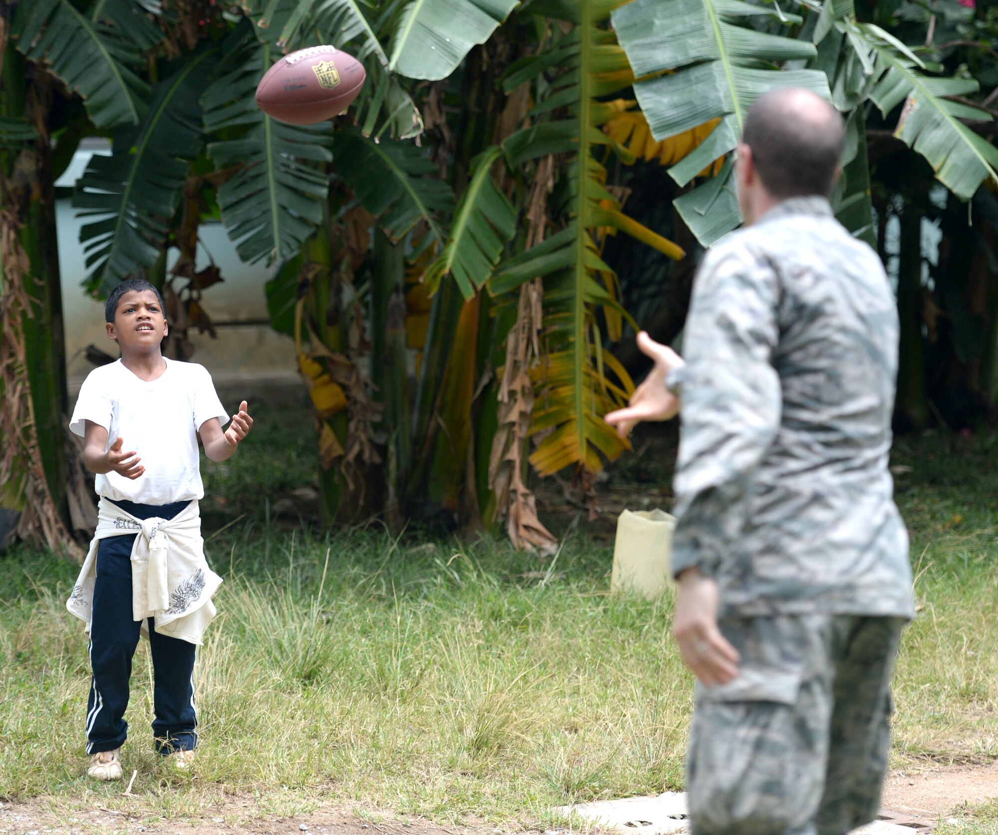 U.S. Maj. Norman Zellers, 60th Medical Operations Squadron, 60th Medical Group physician assistant, out of Travis Air Force Base, Calif., and Allentown, Pa., tosses a football to Lucas Arellano Paz, 13, during the Guardians of the Fatherland event at Puerto Castillo Naval Base in Trujillo, Honduras, June 6, 2015. More than 20 NEW HORIZONS Honduras 2015 personnel volunteered to participate in the event. NEW HORIZONS was launched in the 1980s and is an annual joint humanitarian assistance exercise that U.S. Southern Command conducts with a partner nation in Central America, South America or the Caribbean. The exercise improves joint training readiness of U.S. and partner nation civil engineers, medical professionals and support personnel through humanitarian assistance activities. (U.S. Air Force photo by Capt. David J. Murphy/Released)
