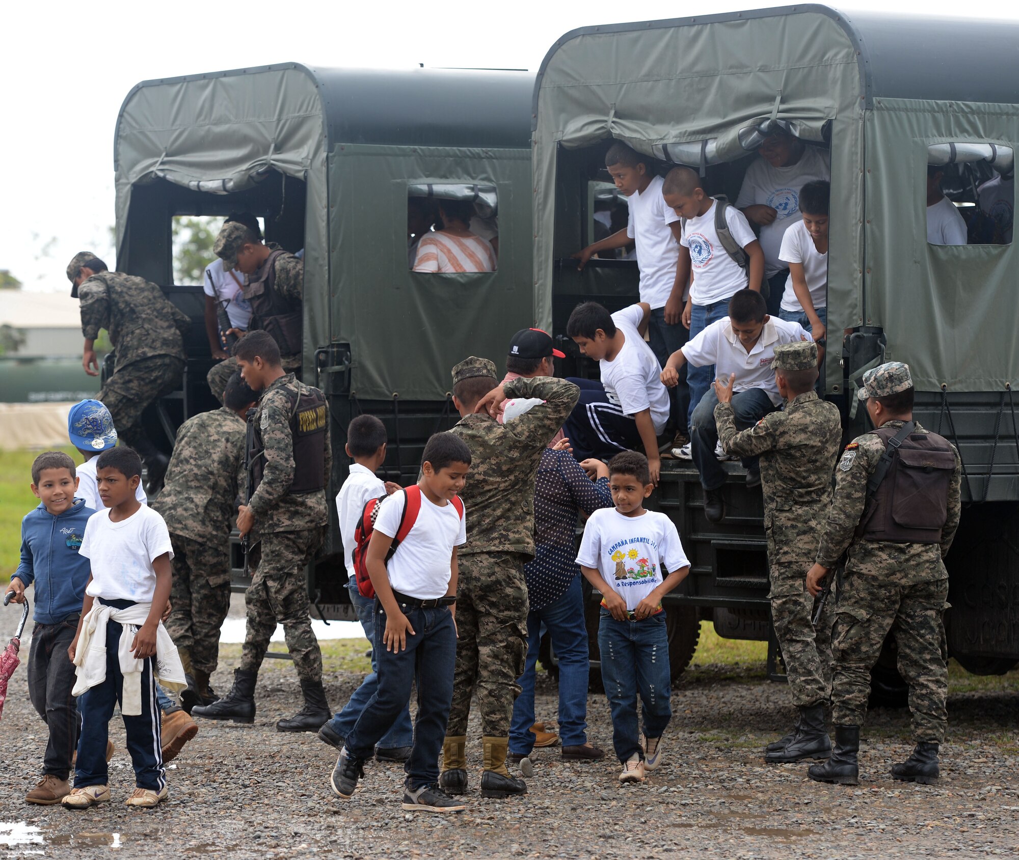 Children from the surrounding communities arrive at Puerto Castillo Naval Base in Trujillo, Honduras, June 6, 2015, to participate in the Guardians of the Fatherland event. Guardians goes twice and year and includes about 200 children per session. Each session lasts about 6 months, every Saturday and includes classes on civic values, military values, spiritual values and human rights. NEW HORIZONS Honduras 2015 personnel also participated in the event which they plan to participate in every Saturday throughout the duration of their time in Honduras. NEW HORIZONS was launched in the 1980s and is an annual joint humanitarian assistance exercise that U.S. Southern Command conducts with a partner nation in Central America, South America or the Caribbean. The exercise improves joint training readiness of U.S. and partner nation civil engineers, medical professionals and support personnel through humanitarian assistance activities. (U.S. Air Force photo by Capt. David J. Murphy/Released)