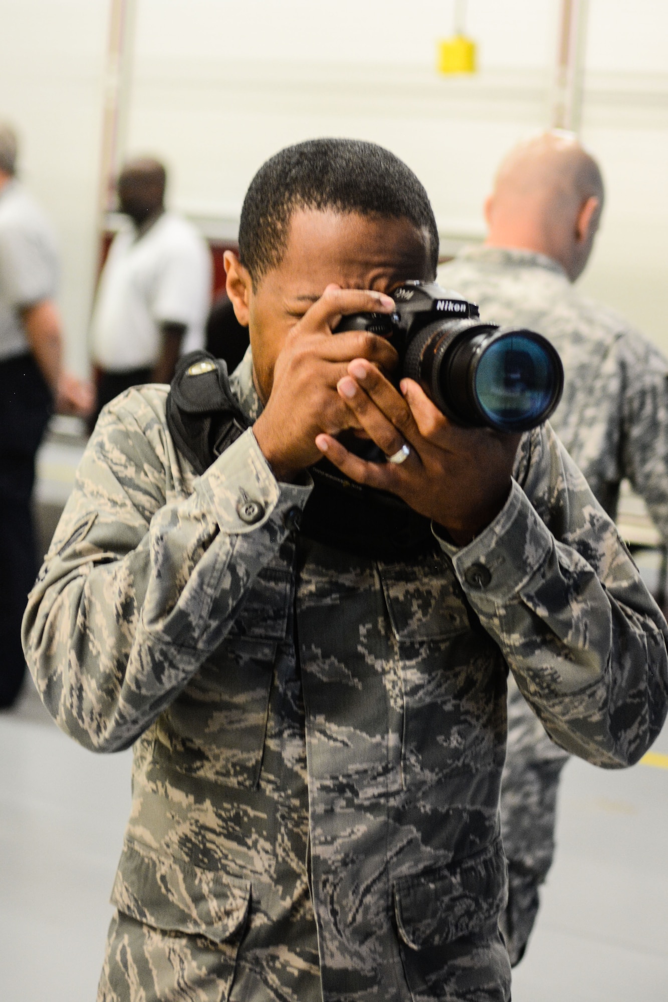 U.S. Air Force Senior Airman Bruce Jenkins, a crew chief assigned to the 139th Maintenance Group, Missouri Air National Guard, photographs an event at Rosecrans Air National Guard Base, St. Joseph, Mo., June 3, 2015. Jenkins is a temporary technician assigned to the 139th Public Affairs Office as an audiovisual production specialist. (U.S. Air National Guard photo by Tech. Sgt. Michael Crane)