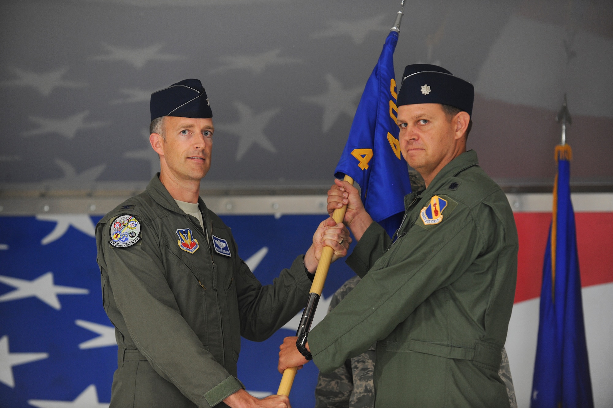 Col. Brian Afflerbaugh, 4th Operations Group commander, passes the guidon to Lt. Col. Trent Tripple, incoming 4th Training Squadron commander, during the 4th TS change of command ceremony, June 5, 2015, at Seymour Johnson Air Force Base, North Carolina. The training squadron conducts all the initial academic and simulator training for every F-15E Strike Eagle pilot and Weapon Systems Officer in the Air Force. (U.S. Air Force photo/Airman 1st Class Aaron J. Jenne)