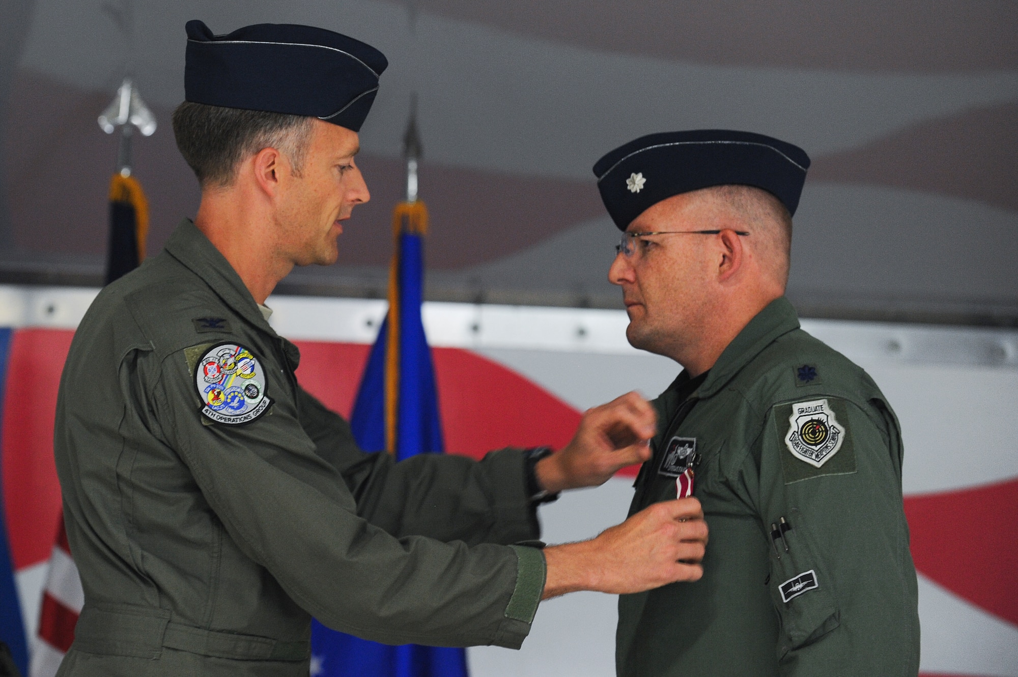 Col. Brian Afflerbaugh, 4th Operations Group commander, presents Lt. Col. David Evans, outgoing 4th Training Squadron commander, with a Meritorious Service Medal during the 4th TS change of command ceremony, June 5, 2015, at Seymour Johnson Air Force Base, North Carolina. Evans relinquished command to Lt. Col. Trent Tripple. (U.S. Air Force photo/Airman 1st Class Aaron J. Jenne)