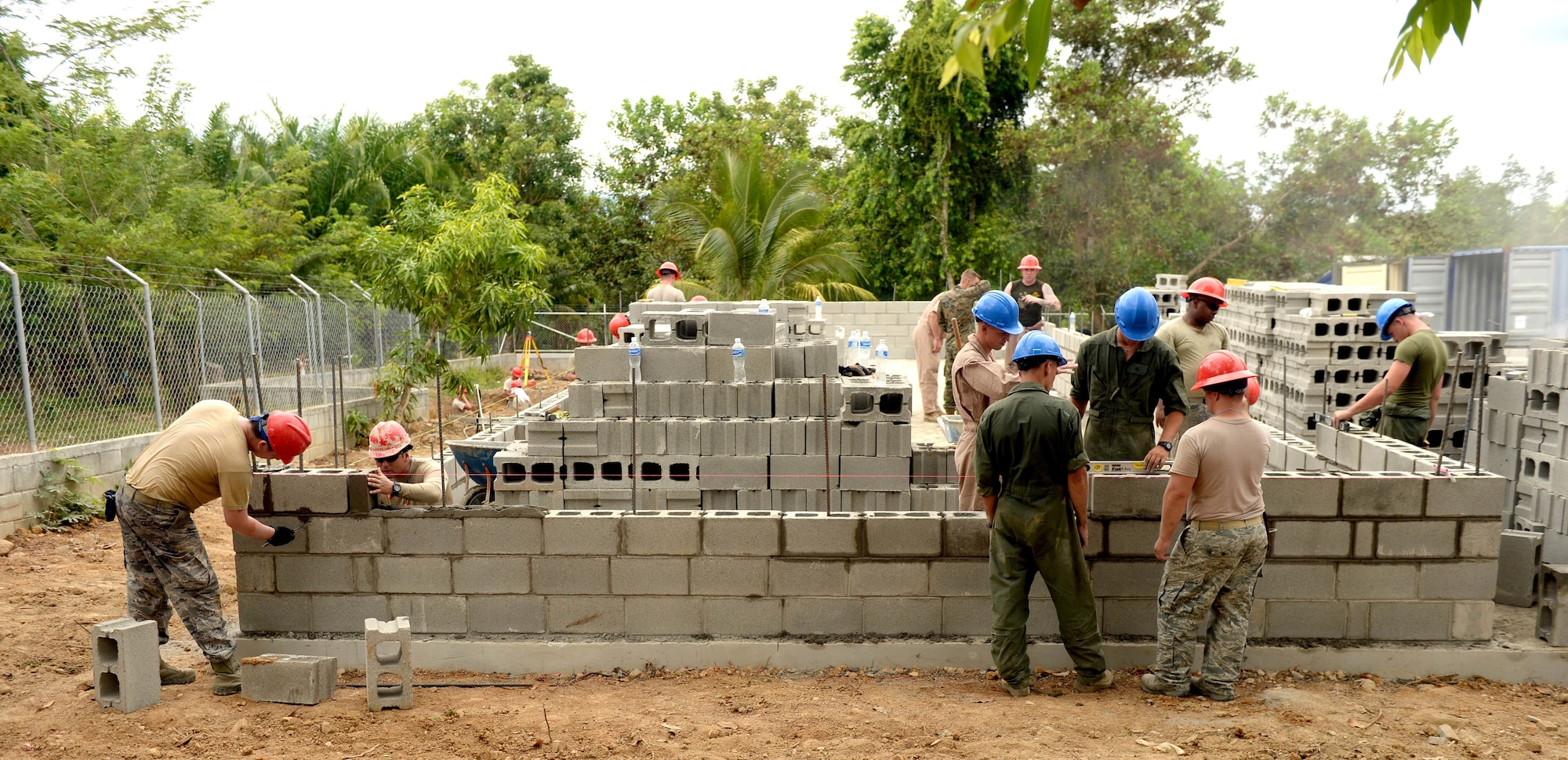 U.S. Air Force Airmen from the 823rd Expeditionary RED HORSE Squadron, out of Hurlburt Field, Fla., and U.S. Marines from the 271st Marine Wing Support Squadron, 2nd Marine Air Wing, out of Marine Corps Air Station Cherry Point, N.C., lay bricks at the Gabriela Mistral school in Ocotes Alto, Honduras, June 3, 2015. The Airmen and Marines work together as part of the New Horizons Honduras 2015 training exercise, an annual humanitarian exercise put on by U.S. Southern Command. New Horizons was launched in the 1980s and is an annual joint humanitarian assistance exercise that U.S. Southern Command conducts with a partner nation in Central America, South America or the Caribbean. The exercise improves joint training readiness of U.S. and partner nation civil engineers, medical professionals and support personnel through humanitarian assistance activities. (U.S. Air Force photo by Capt. David J. Murphy/Released)