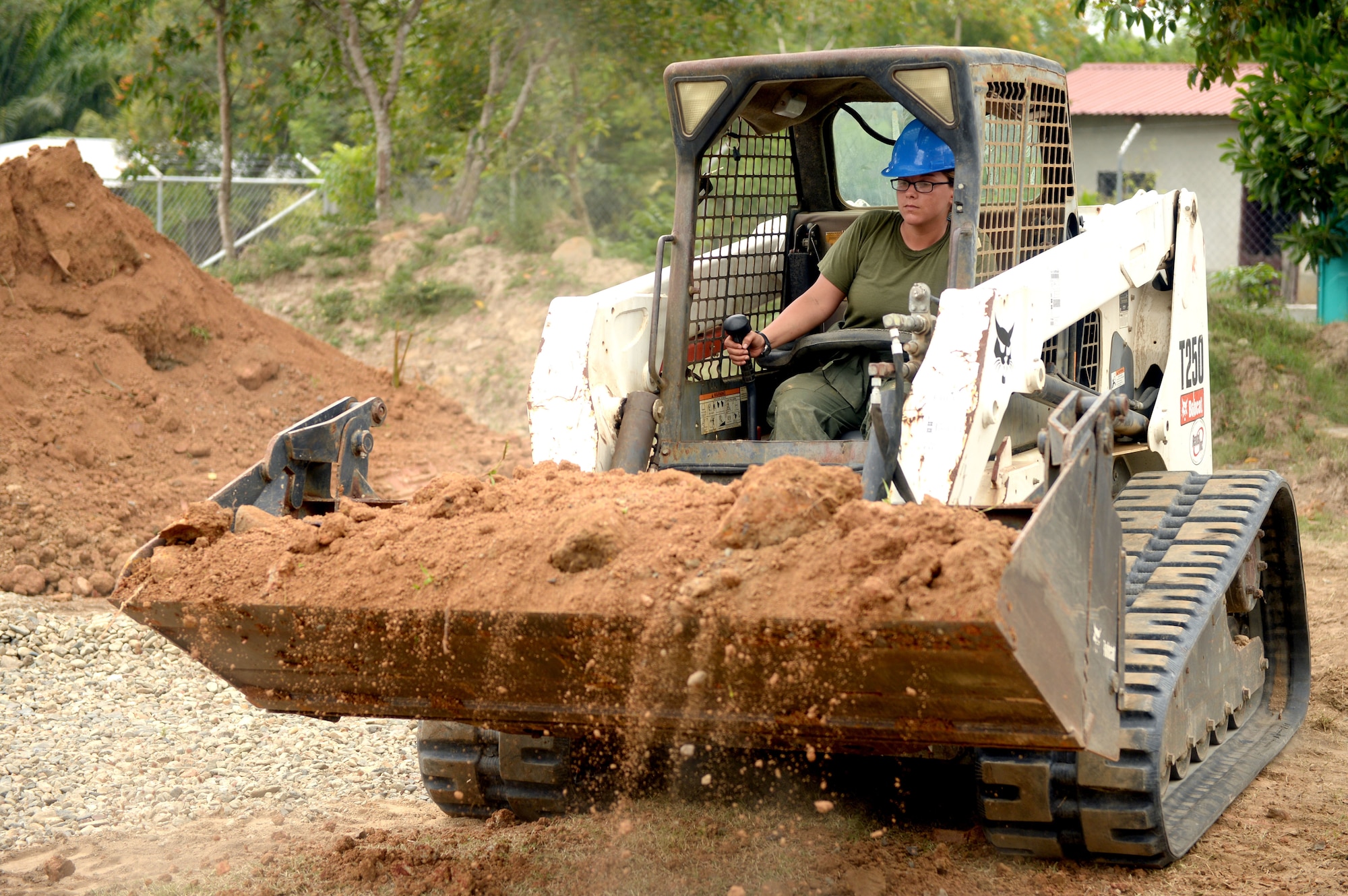 U.S. Marine Lance Corporal Rikki Dominey, a heavy equipment operator with a 271st Marine Wing Support Squadron, 2nd Marine Air Wing, out of Marine Corps Air Station Cherry Point, N.C., moves dirt using a Bobcat T190 dirt mover at Gabriela Mistral primary school in Ocotes Alto, Honduras, June 3, 2015. The school project is one part of the New Horizons Honduras 2015 training exercise, an annual humanitarian and event organized by U.S. Southern Command. New Horizons was launched in the 1980s and is an annual joint humanitarian assistance exercise that U.S. Southern Command conducts with a partner nation in Central America, South America or the Caribbean. The exercise improves joint training readiness of U.S. and partner nation civil engineers, medical professionals and support personnel through humanitarian assistance activities. (U.S. Air Force photo by Capt. David J. Murphy/Released)