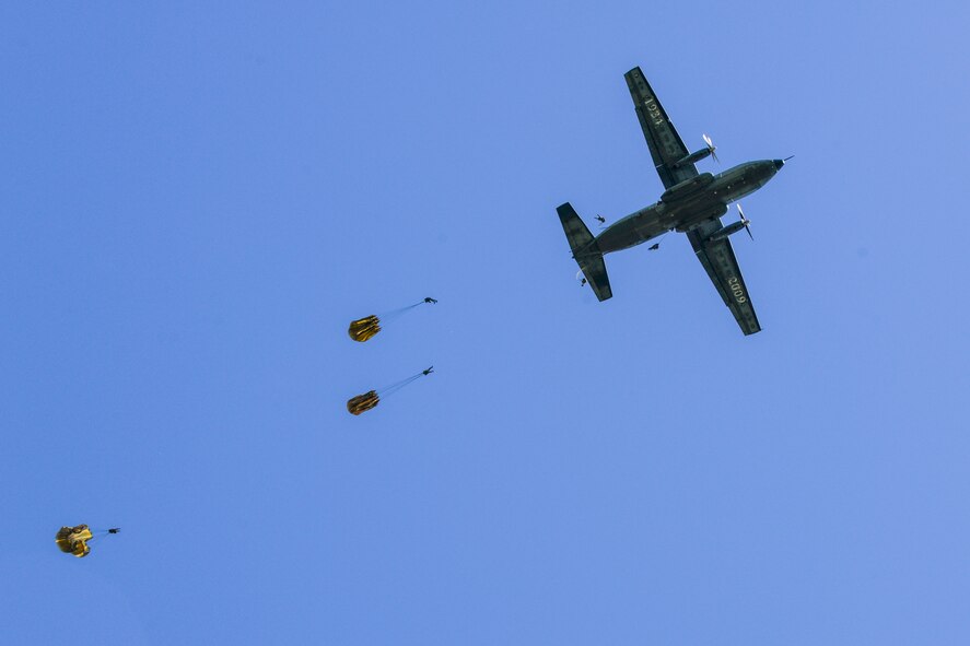 German soldiers parachute over the historic La Fiere drop zone near Sainte Mere Eglise, Normandy, France, June 7, 2015, to commemorate the 71st Anniversary of D-Day. More than 380 U.S. service members from Europe and affiliated D-Day historical units participated in the 71st Anniversary air drop as part of Joint Task Force D-Day 71. The task force, based in Sainte Mere Eglise, France, is supporting local events across Normandy, from June 2-8, 2015, to commemorate the selfless actions by all the Allies on D-Day that continue to resonate 71 years later. (U.S. Air Force photo/Senior Airman Nicole Sikorski)