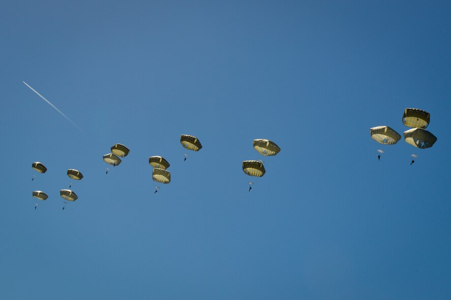 U.S. Army Soldiers parachute over the historic La Fiere drop zone near Sainte Mere Eglise, Normandy, France, June 7, 2015, to commemorate the 71st Anniversary of D-Day. More than 380 U.S. service members from Europe and affiliated D-Day historical units participated in the 71st Anniversary air drop as part of Joint Task Force D-Day 71. The task force, based in Sainte Mere Eglise, France, is supporting local events across Normandy, from June 2-8, 2015, to commemorate the selfless actions by all the Allies on D-Day that continue to resonate 71 years later.