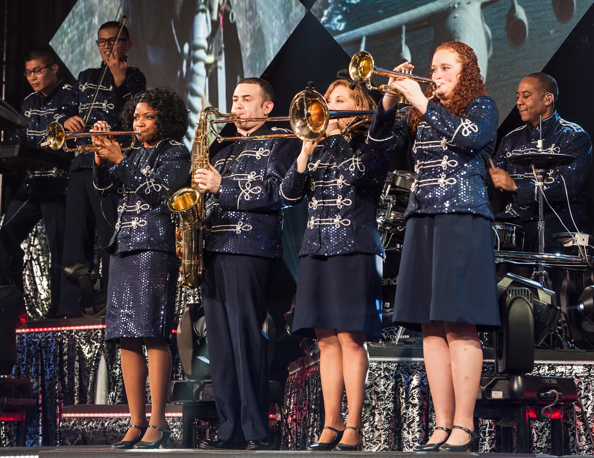 1st Lt. Natalie Lane, flight chief with the 1st Special Operations Force Support Squadron at Hurlburt Field, plays the trombone in the four horn arrangement during Tops in Blue’s Freedom’s Song World Tour at the Emerald Coast Convention Center, June 6 in Fort Walton Beach, Fla. The Hendersonville, N.C. native was one of 37 Airmen selected for the special unit based on her ability to entertain.  The TIB team is also the “road crew” for each show. Managed by seven technical personnel, they are responsible for the transporting and setting up more than 65,000 pounds of stage equipment.  TIB’s mission is to provide entertainment to military personnel and their families at home and abroad.  (U.S. Air Force photo/Ilka Cole)