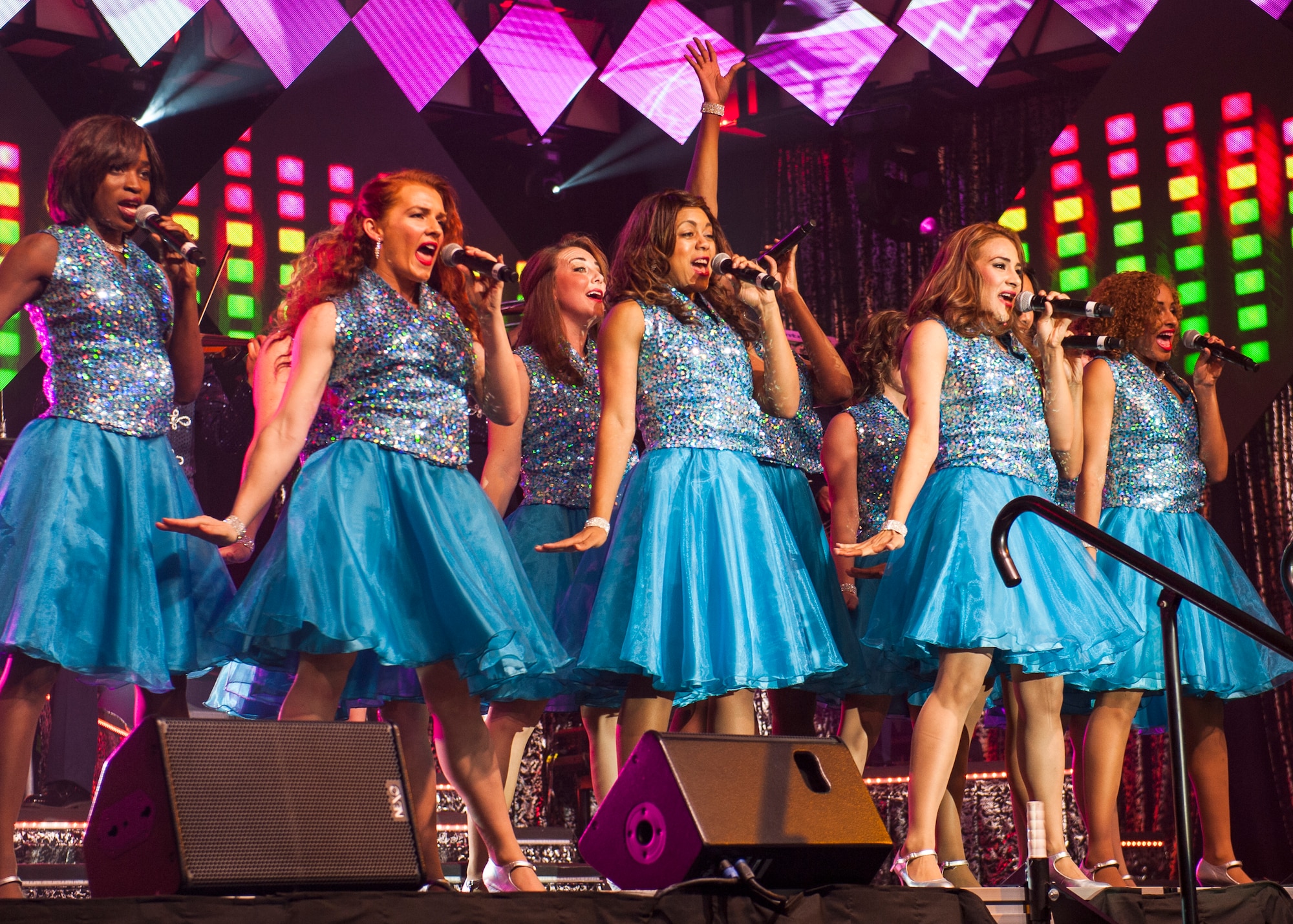 A Tops In Blue ensemble performs during their Freedom’s Song World Tour at the Emerald Coast Convention Center, June 6 in Fort Walton Beach, Fla. They were among 37 Airmen selected for the special unit based on their ability to entertain.  The TIB team is also the “road crew” for each show.  Managed by seven technical personnel, they are responsible for the transporting and setting up more than 65,000 pounds of stage equipment.  TIB’s mission is to provide entertainment to military personnel and their families at home and abroad. (U.S. Air Force photo/Ilka Cole)