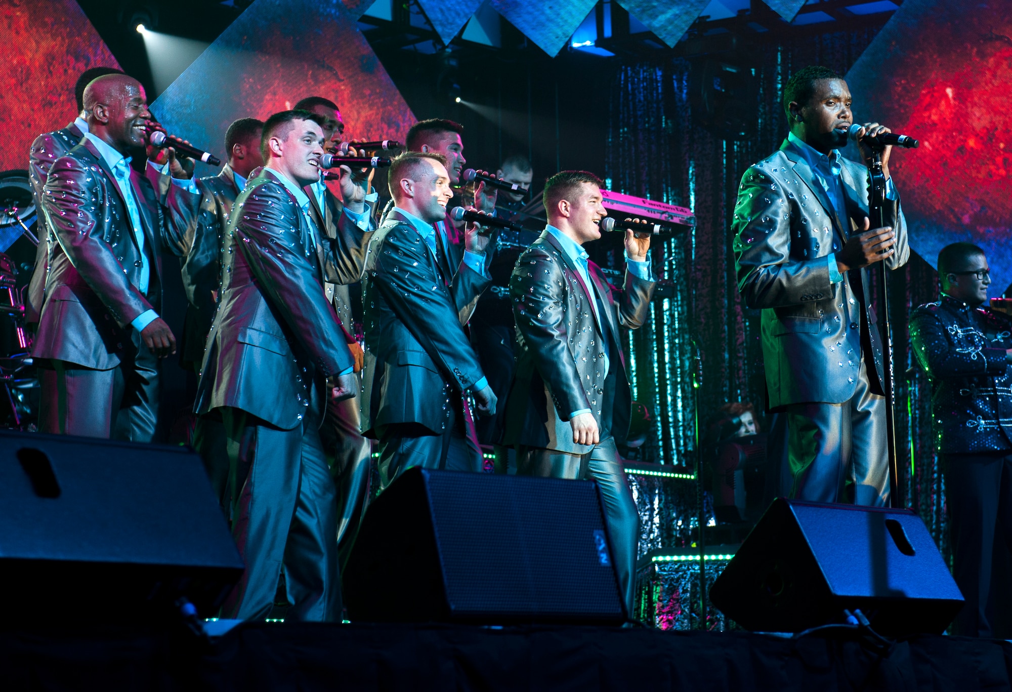 Senior Airman Jordan Whitehead, sings with Tops In Blue teammates during their Freedom’s Song World Tour at the Emerald Coast Convention Center, June 6 in Fort Walton Beach, Fla. The Richmond, Va. Native and fellow performers were among 37 Airmen selected for the special unit based on their ability to entertain.  The TIB team is also the “road crew” for each show.  Managed by seven technical personnel, they are responsible for the transporting and setting up more than 65,000 pounds of stage equipment.  TIB’s mission is to provide entertainment to military personnel and their families at home and abroad. (U.S. Air Force photo/Ilka Cole)