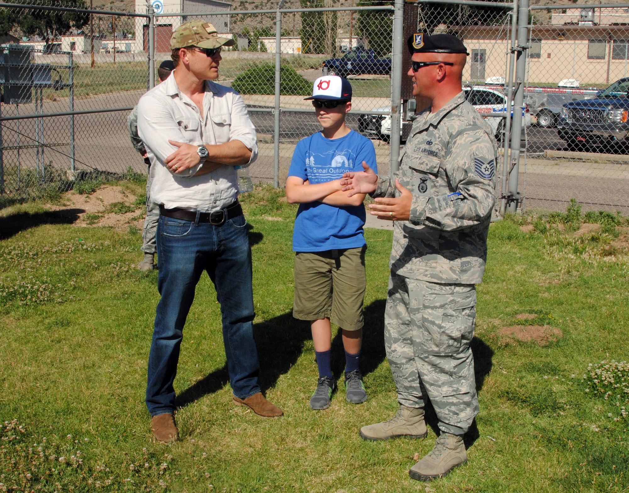 Actor Cole Hauser (left) and his son Ryland get a briefing from Tech Sgt. Daniel Wilson, NCOIC of the 377th Security Forces Group's military working dog section June 3. Hauser visited Kirtland as part of a USO-sponsored event where he screened an unreleased episode of the DirectTV series "Rogue," in which he is one of the stars. (Photo by Jim Fisher)
