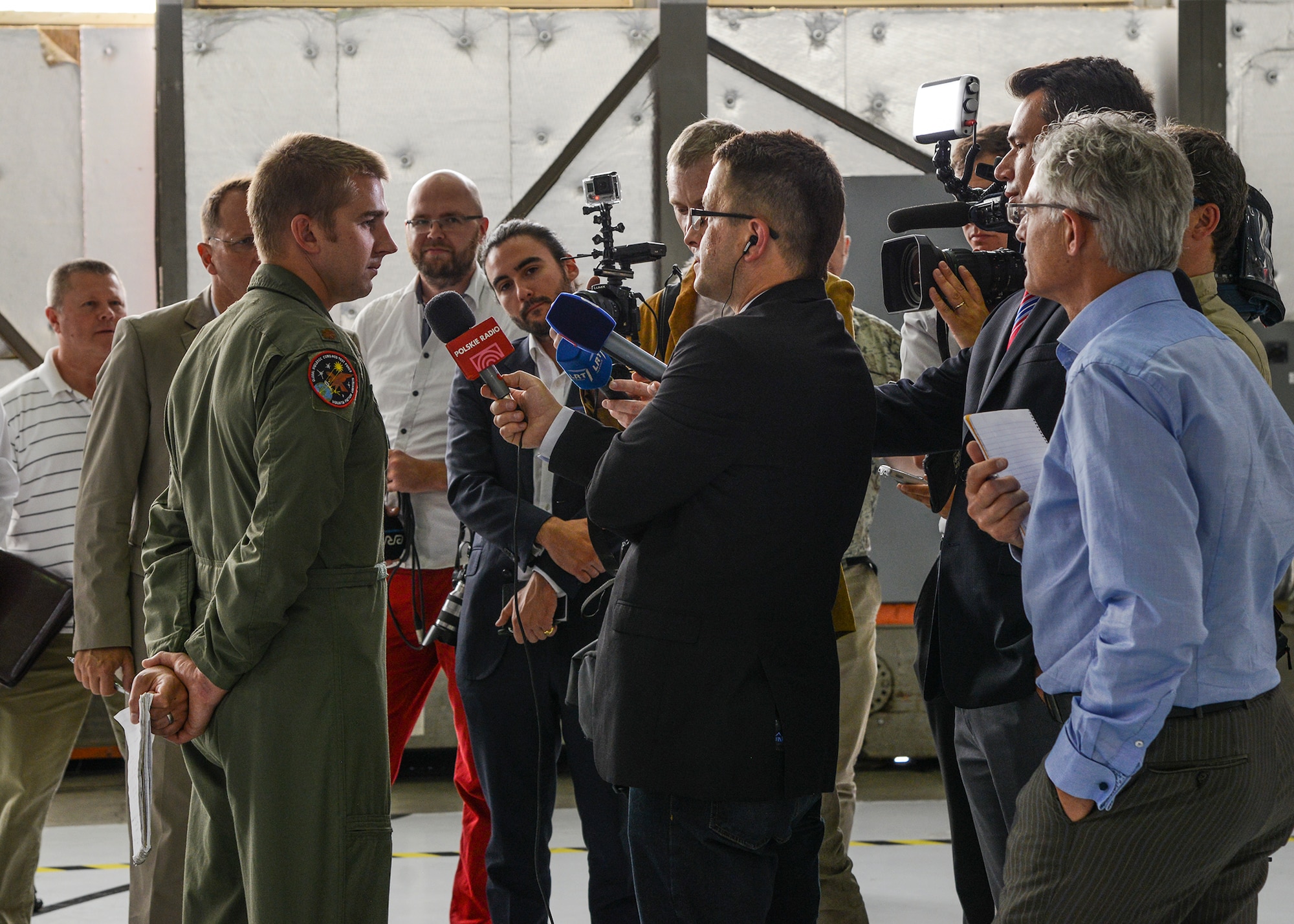 Maj. Jeremy Jones, Global Hawk pilot, answers questions about the Global Hawk and the unique mission of flying an unmanned airplane June 4. European journalists visited the Global Vigilance Combined Test Force at Edwards AFB where they saw a Block 20/30 Global Hawk after the NATO AGS rollout earlier in the day. (U.S. Air Force photo by Rebecca Amber)