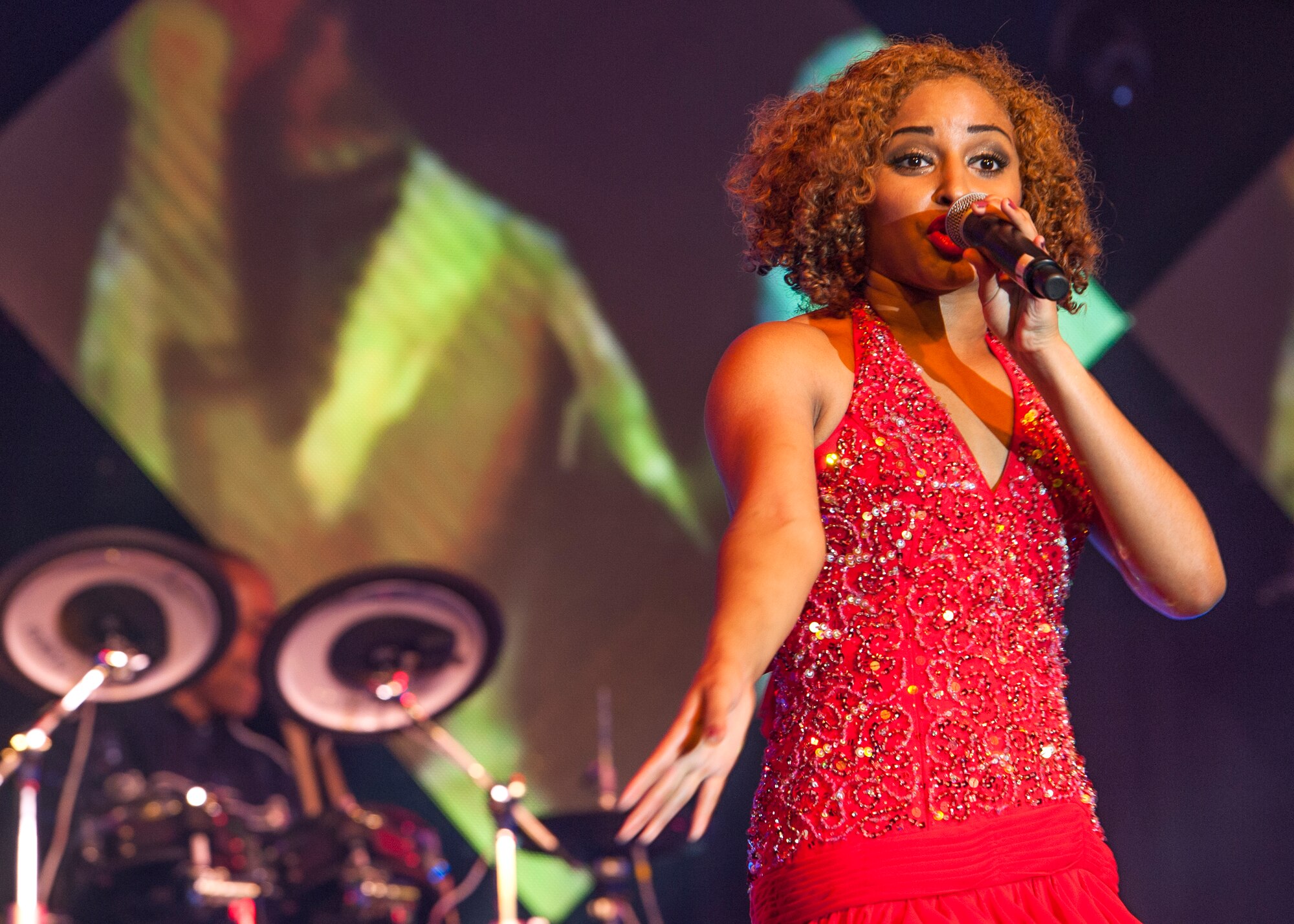 2nd Lt. Nicque Robinson sings during Tops in Blue’s Freedom’s Song World Tour at the Emerald Coast Convention Center, June 6 in Fort Walton Beach, Fla. The Houston, Texas native was one of 37 Airmen selected for the special unit based on her ability to entertain.  The TIB team is also the “road crew” for each show. Managed by seven technical personnel, they are responsible for the transporting and setting up more than 65,000 pounds of stage equipment.  TIB’s mission is to provide entertainment to military personnel and their families at home and abroad.  (U.S. Air Force photo/Ilka Cole)