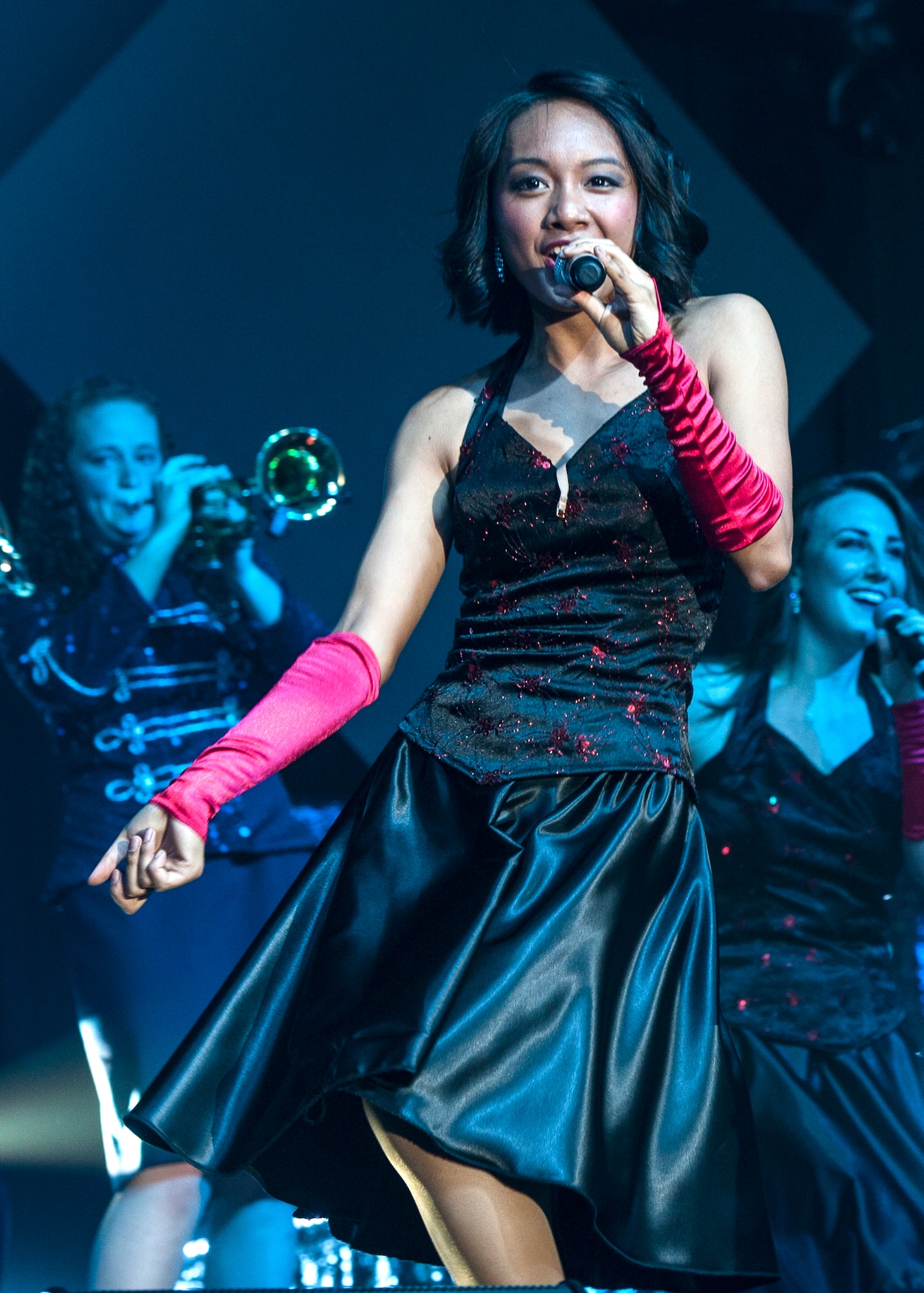 Airman 1st Class Christine Marie David, an administration journeyman with the 96th Aircraft Maintenance Squadron at Eglin, sings during Tops in Blue’s Freedom’s Song World Tour at the Emerald Coast Convention Center, June 6 in Fort Walton Beach, Fla. The Renton, Wash., native was one of 37 Airmen selected for the special unit based on her ability to entertain.  The TIB team is also the “road crew” for each show. Managed by seven technical personnel, they are responsible for the transporting and setting up more than 65,000 pounds of stage equipment. TIB’s mission is to provide entertainment to military personnel and their families at home and abroad.  (U.S. Air Force photo/Ilka Cole)