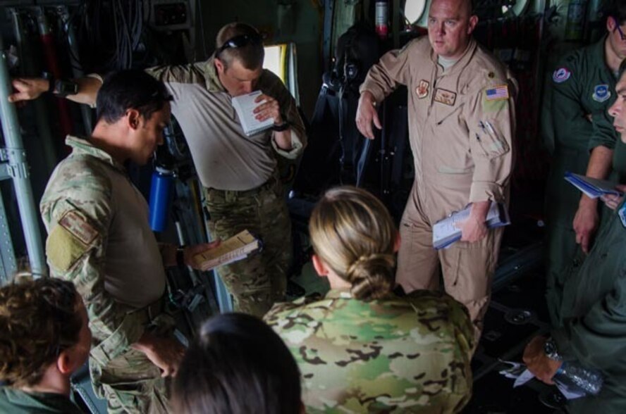 U.S. Air Force Maj. Neil Harlow, with the 153rd Airlift Wing, gives an aircraft commander’s briefing to Airmen assigned to the 38th Rescue Squadron out of Moody Air Force Base, Ga., and aircrew from the Wyoming Air National Guard’s 153rd Airlift Wing June 7, 2015, prior to take off aboard a C-130 Hercules aircraft at Davis-Monthan Air Force Base, Ariz. The aircraft commander’s briefing was given to ensure the flight crew was informed and in sync for their upcoming mission. The mission was conducted as part of Angel Thunder 2015, the world’s largest personnel recovery exercise, hosting 11 partner nations and nine inter-agencies. (U.S. Air National Guard photo by Tech. Sgt. John Galvin/Released)