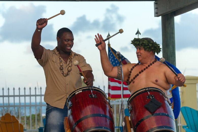 Senior Airman Darren Watts, cyber transport systems journeyman from the Air Force Technical Application Center, left, takes instructions from one of the performers while trying to play the Samoan drums at the Asian American and Pacific Islander Heritage Luau May 29, 2015 at the Beach House at Patrick Air Force Base, Fla. The Luau is part of an observance held annually from May 1 - 31 in celebration of Asian American and Pacific Islander Heritage Month. (U.S. Air Force photo/Cory Long) (Released)