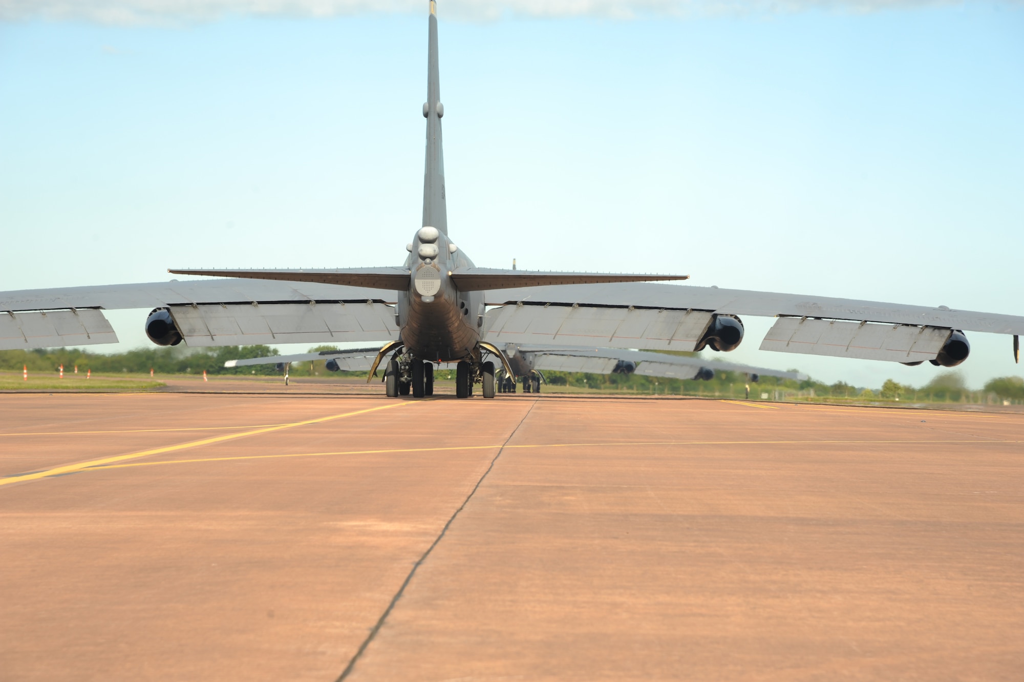 Two B-52H Stratofortresses from Minot Air Force Base, N.D., taxi onto the runway at Royal Air Force Fairford, England, June 8, 2015 to complete the first mission in support of exercise Saber Strike 15. Bomber operations provide a credible, flexible and ready capability to respond to a variety of potential threats and situations. The three B-52s forward deployed in support of Saber Strike 15 to help promote regional stability and security. (U.S. Air Force photos/Capt. Christopher Mesnard)