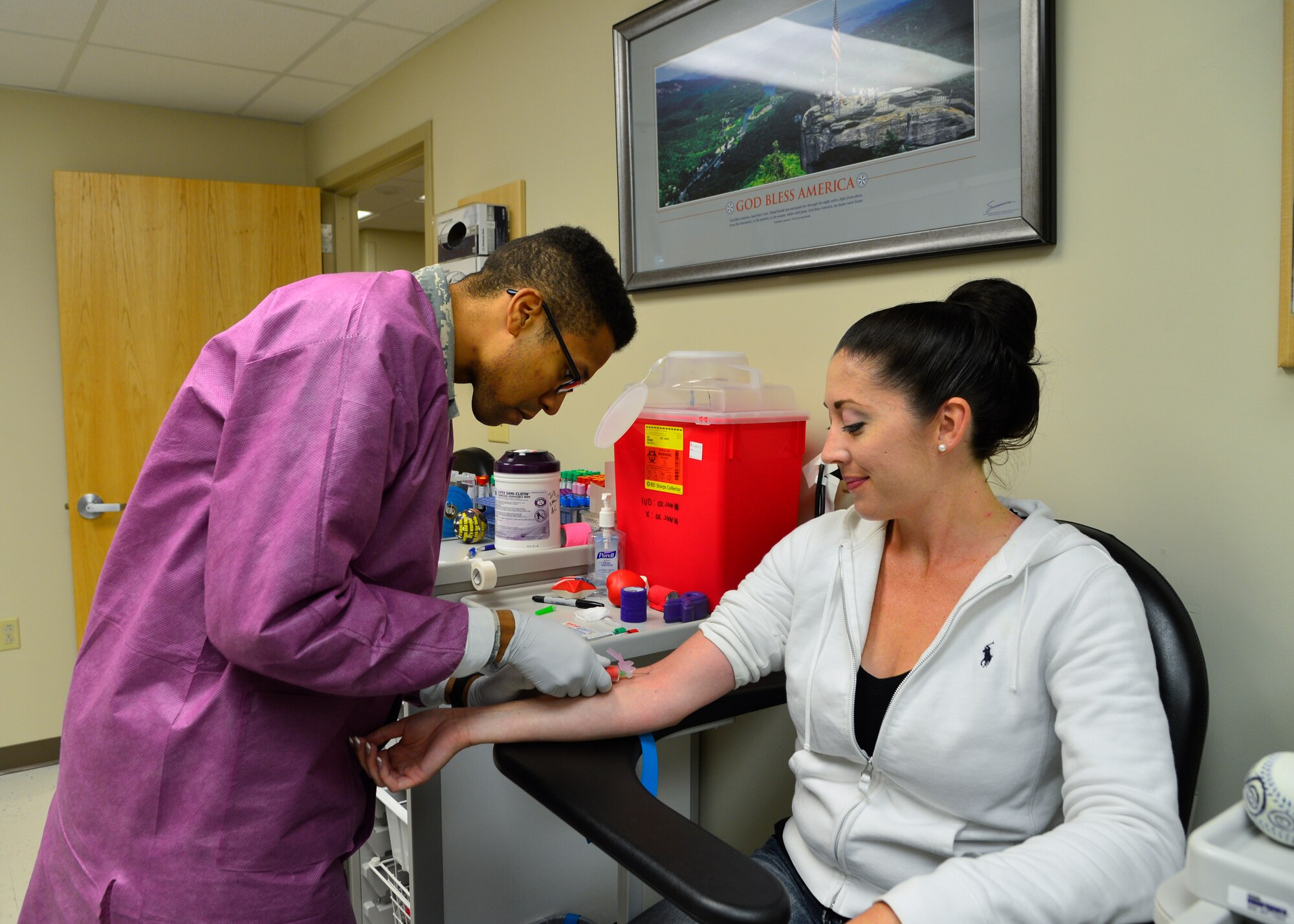Airman 1st Class Tchaz Amevor-Brown, 436th Medical Support Squadron Clinical Laboratory technician, draws blood from Staff Sgt. Mary Bailey, 9th Airlift Squadron loadmaster, June 5, 2015, at the Clinical Laboratory on Dover Air Force Base, Del. The lab recently received their accreditation from the College of American Pathologists (CAP) and process more than 140,000 specimens a year. (U.S. Air Force photo/Airman 1st Class William Johnson)
