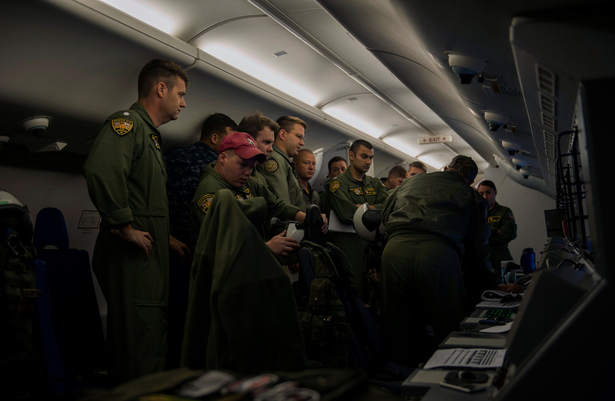 Members of U.S. Navy Patrol Squadron Eight from Naval Air Station Jacksonville, Fla., huddle for a meeting in a Boeing P-8 Poseidon maritime surveillance aircraft during a BALTOPS 2015 mission on the flightline of Spangdahlem Air Base, Germany, June 9, 2015. BALTOPS 2015 aims to enhance flexibility and interoperability, as well as demonstrate resolve among allied and partner forces to defend the Baltic region. (U.S. Air Force photo by Airman 1st Class Timothy Kim/Released)
