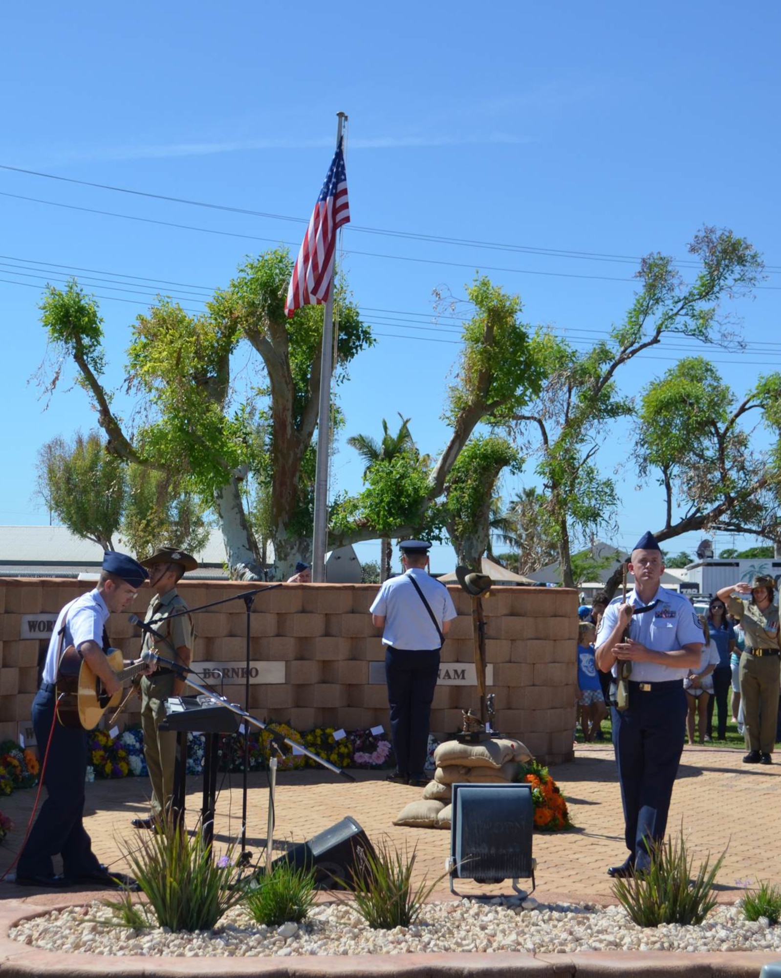 U.S. Air Force Maj. James Hughes, Detachment 1, 2nd Weather Squadron commander, prepares to perform the U.S. national anthem while U.S. Air Force Tech. Sgt. Joshua Leguillon, Det. 1, 2nd WS Solar Electro Optical Network maintenance technician, represents the U.S. Air Force in a five member catafalque party April 25 at Learmonth Solar Observatory, Exmouth, Australia. They were a part of the dawn service for the 100th anniversary of ANZAC, or Australian and New Zealand Army Corps, Day. (U.S. Air Force courtesy photo)