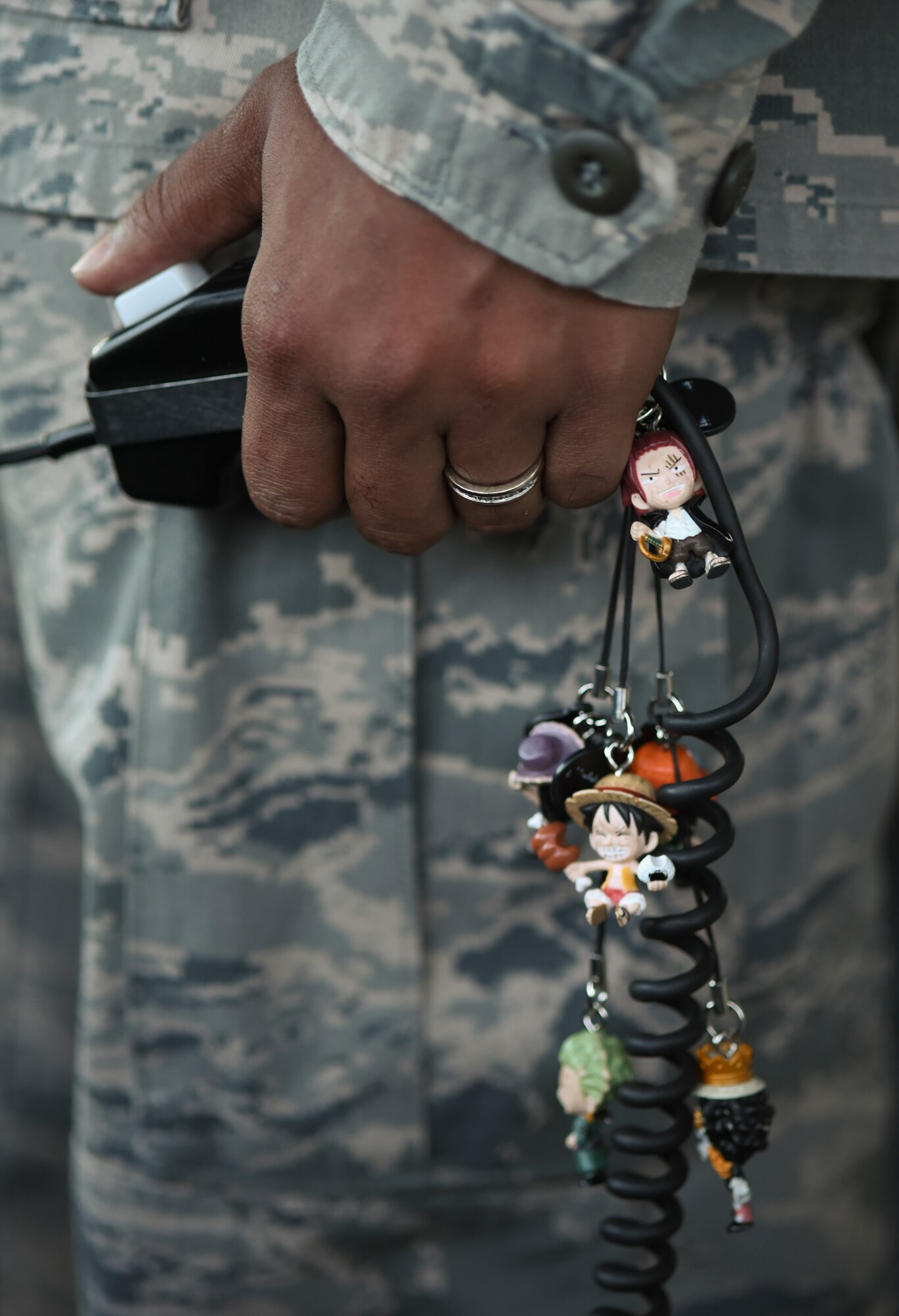 Staff Sgt. Randall Vaughn, 374th Operations Support Squadron radar approach control supervisor, touches his personalized headset at the air traffic control tower at Yokota Air Base, Japan, May 8, 2015. Vaughn uses the headset to talk to incoming and outgoing aircraft at Yokota. (U.S. Air Force photo by Senior Airman Michael Washburn/Released)