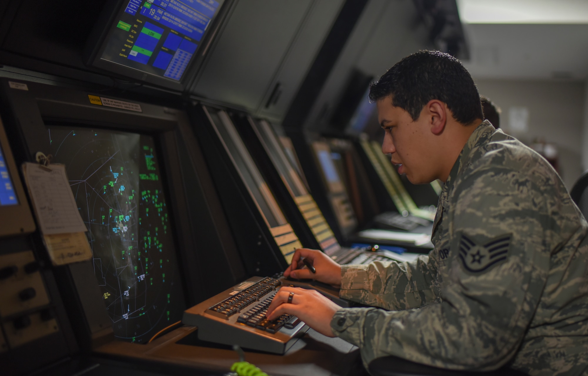 Staff Sgt. Christopher Palacio, 374th Operations Support Squadron air traffic control specialist, operates an approach control station as he separates, sequences and directs aircraft into five different Japanese and U.S. military bases throughout the region at Yokota Air Base, Japan, May 8, 2015. Palacio works in the radar approach control section of the tower, which can monitor and control aircraft in an area of 20,000 square miles. (U.S. Air Force photo by Senior Airman Michael Washburn/Released)