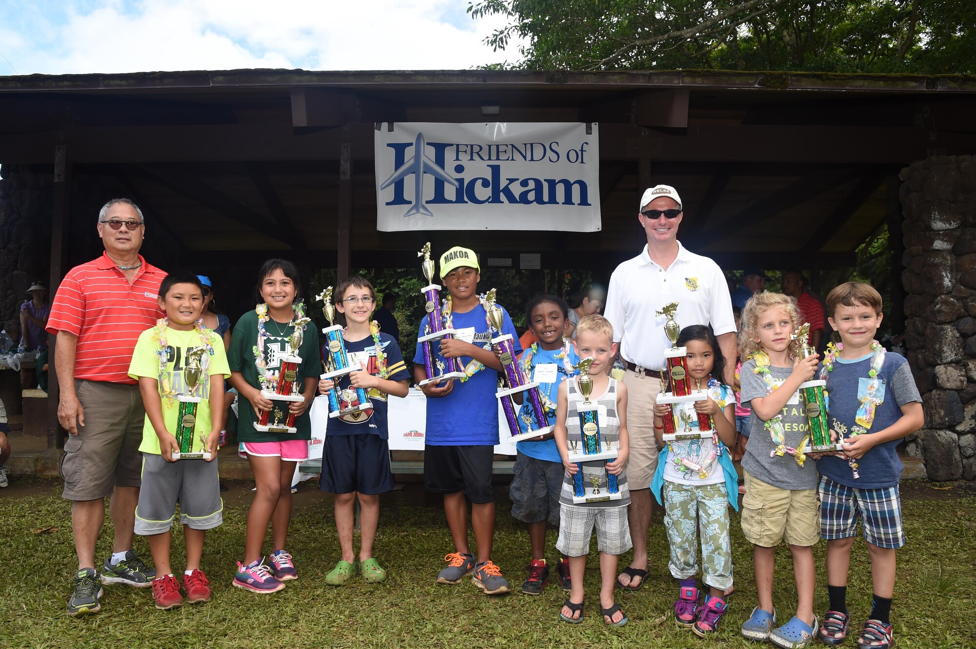 The 16th Annual Friends of Hickam Keiki Fishing Tournament winners pose for a photo with Mr. Stuart Chun, from  Friends of Hickam (Left) and 15th Wing Commander Col. Randall Huiss, at the Ho`omaluhia Botanical Gardens in Kaneohe, Hawaii, June 5, 2015. The winners caught the most fish and the biggest fish in their age bracket. The fishing tournament brings Hickam families together as part of the Hawaiian Aloha spirit to promote family welfare. (U.S. Air Force photo by Tech. Sgt. Aaron Oelrich/Released)
