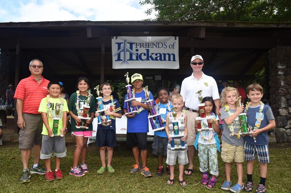 The 16th Annual Friends of Hickam Keiki Fishing Tournament winners pose for a photo with Mr. Stuart Chun, from  Friends of Hickam (Left) and 15th Wing Commander Col. Randall Huiss, at the Ho`omaluhia Botanical Gardens in Kaneohe, Hawaii, June 5, 2015. The winners caught the most fish and the biggest fish in their age bracket. The fishing tournament brings Hickam families together as part of the Hawaiian Aloha spirit to promote family welfare. (U.S. Air Force photo by Tech. Sgt. Aaron Oelrich/Released)