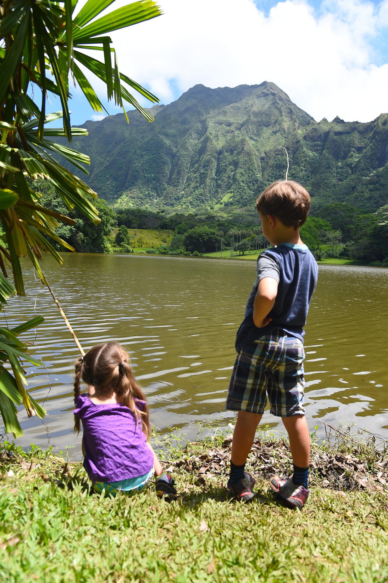 Emelia and Charley Oelrich fish with bamboo fishing poles during the 16th Annual Friends of Hickam Keiki Fishing Tournament  at the Ho`omaluhia Botanical Gardens in Kaneohe, Hawaii, June 5, 2015. The fishing tournament was free for JBPHH Children ages 5-12.(U.S. Air Force photo by Tech. Sgt. Aaron Oelrich/Released)